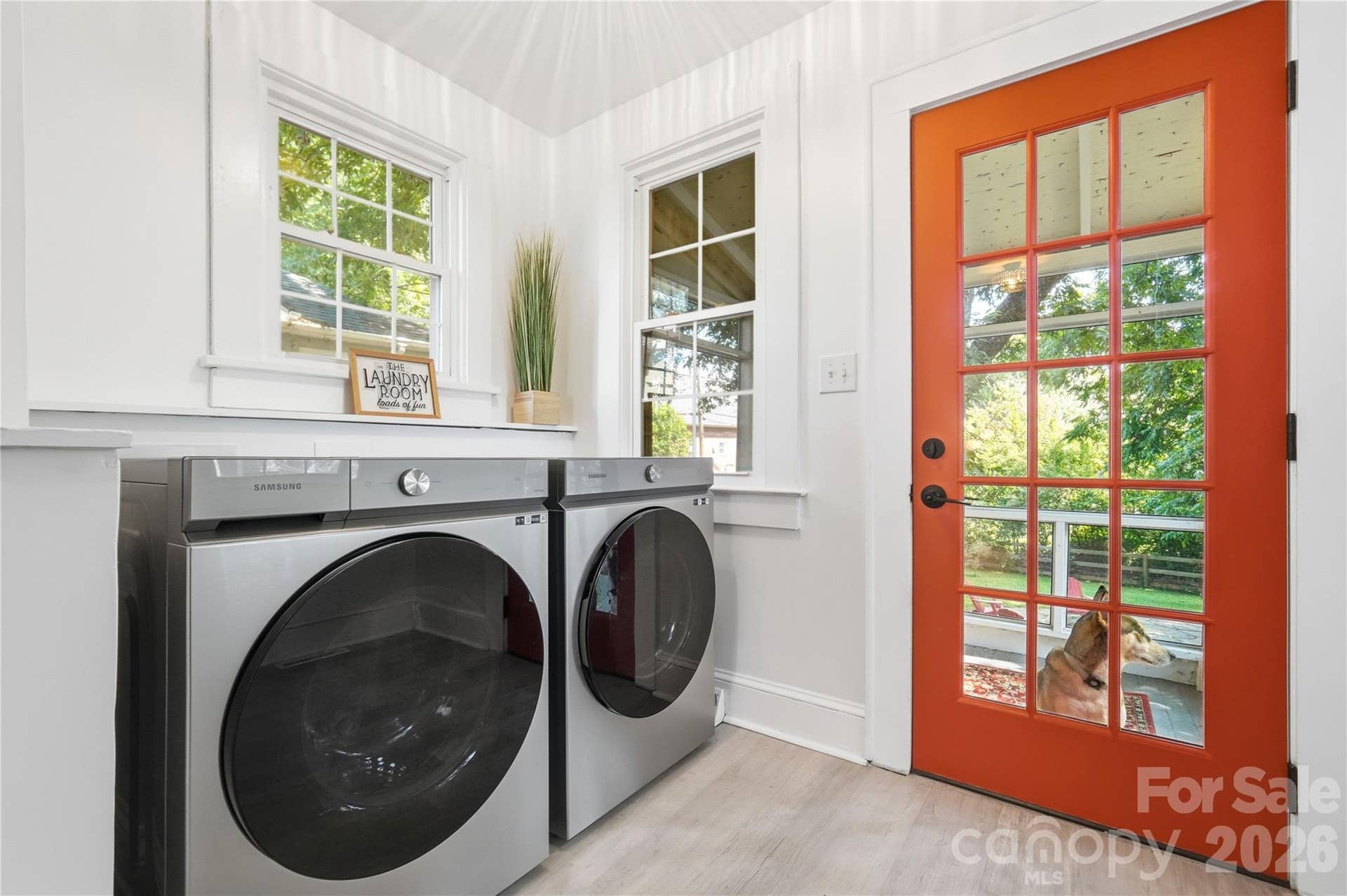 This dedicated laundry area sits right off the kitchen, with a door leading straight out to the backyard for easy access. (Puppy not included.)