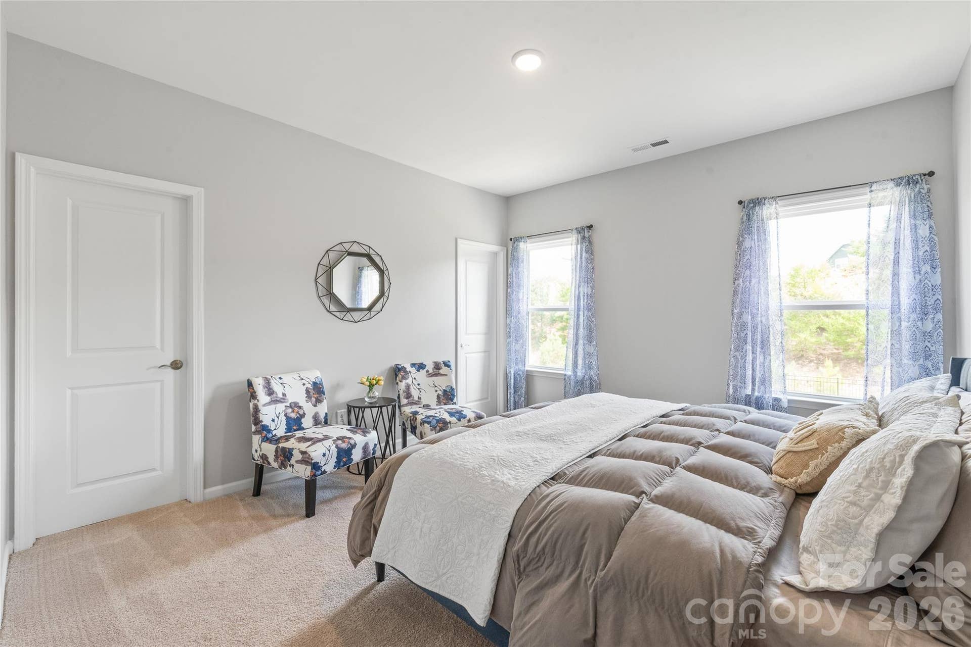 A spacious bedroom featuring a generous walk-in closet and direct access to a shared full bathroom.