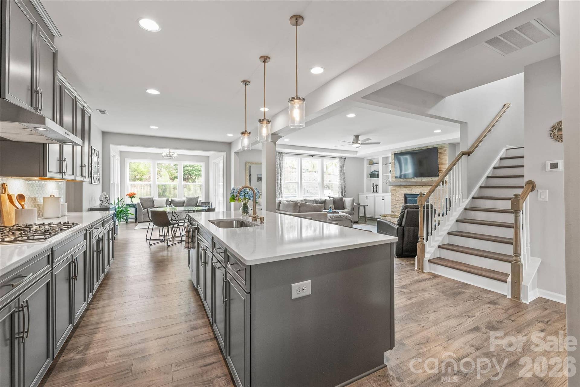 The ultimate open-concept layout...the kitchen connects seamlessly to the sunlit breakfast area, cozy living room, and cheerful sunroom for effortless everyday living and entertaining.