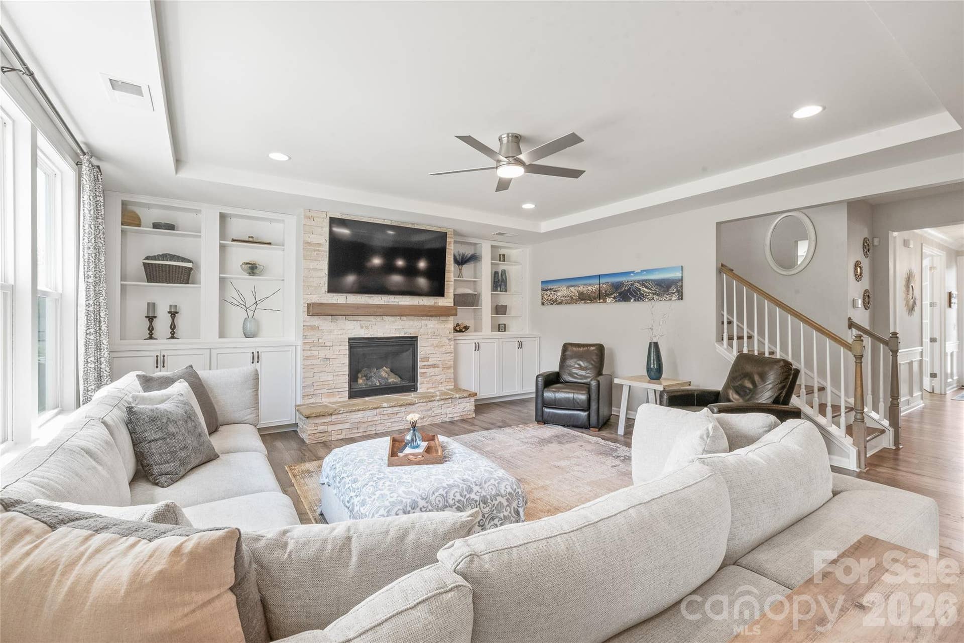 Highlighted by an elegant trey ceiling with soft recessed lighting, the living room offers an elevated, atmospheric setting for relaxed evenings and effortless entertaining.