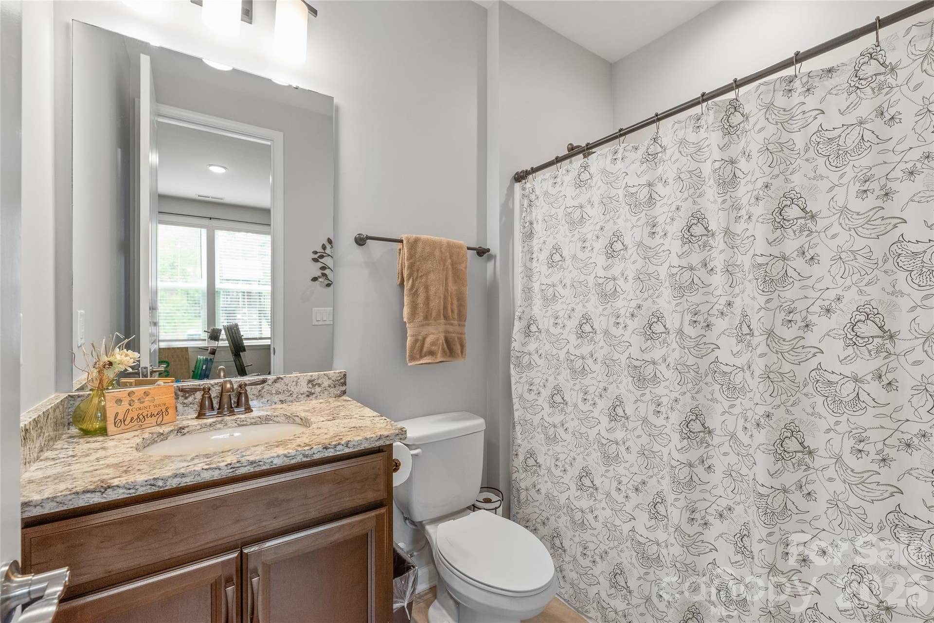Dedicated to the main-floor guest suite, this full bath is equipped with a clean, classic tub/shower combo for ultimate privacy and convenience.