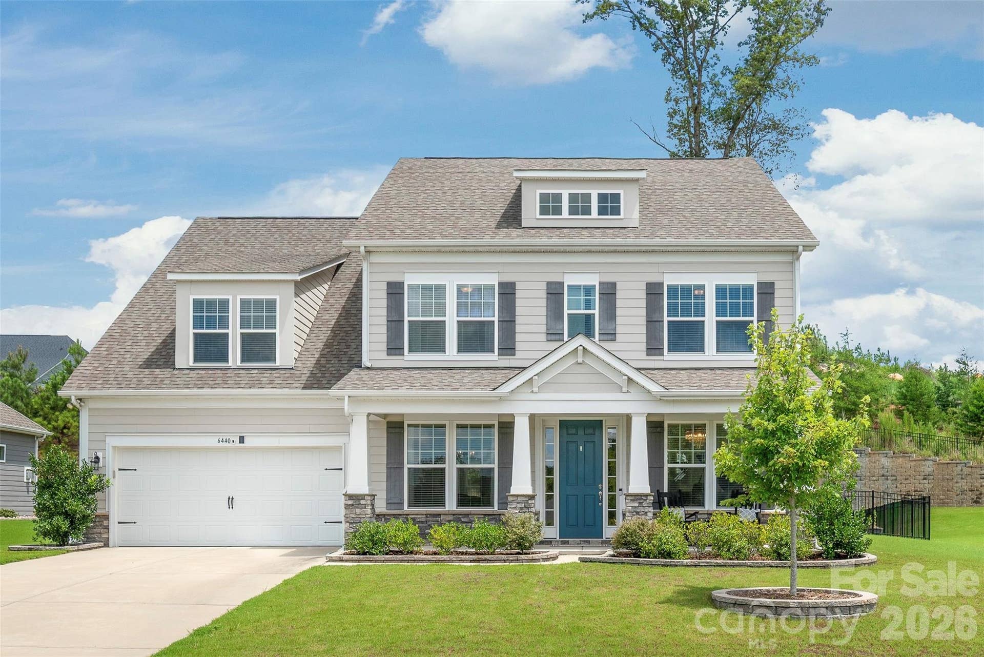 A charming covered porch welcomes you to this stunning Arts and Crafts exterior, blending timeless architectural character with exceptional curb appeal.