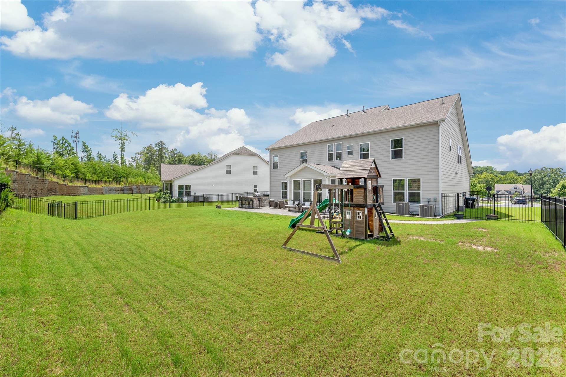 A fully fenced, level backyard that offers privacy and plenty of open space to run...complete with a built-in playset for endless outdoor fun.