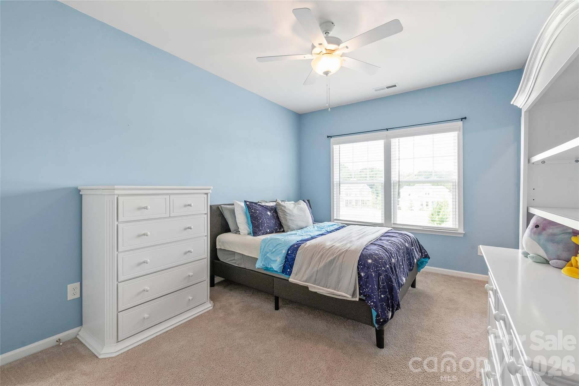 Light-filled and private, this fourth bedroom offers a roomy walk-in closet and seamless Jack-and-Jill bath connectivity.