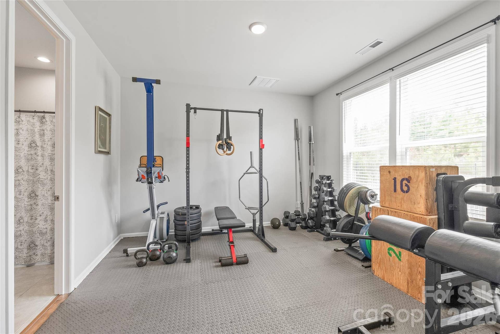 Conveniently located on the main level, this spacious guest bedroom offers complete privacy and access to its own private full bathroom, making it ideal for visitors, multi-generational living, or even a home gym.