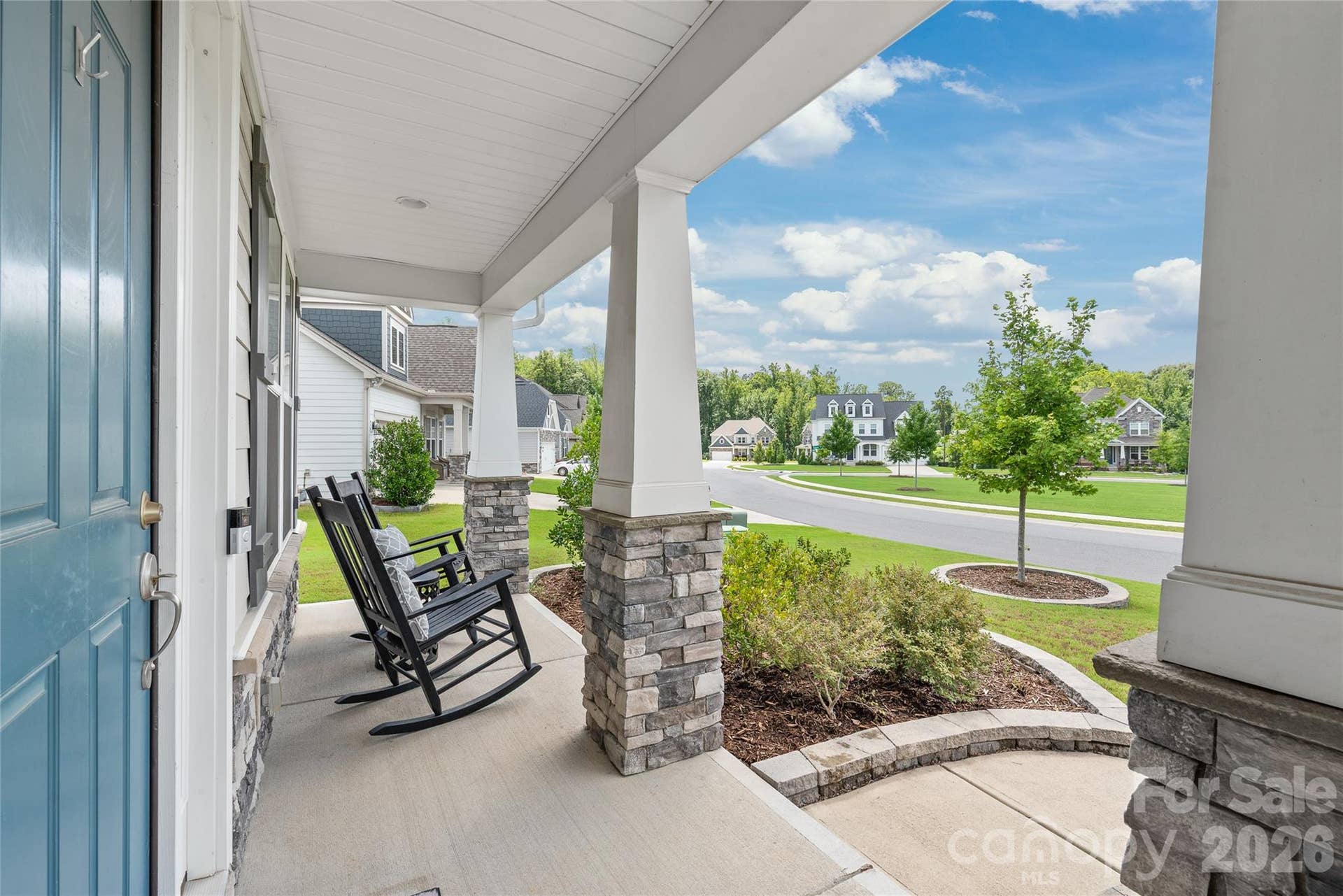 Unwind on the inviting covered porch, the perfect spot to sip your morning coffee or relax and watch the world go by.
