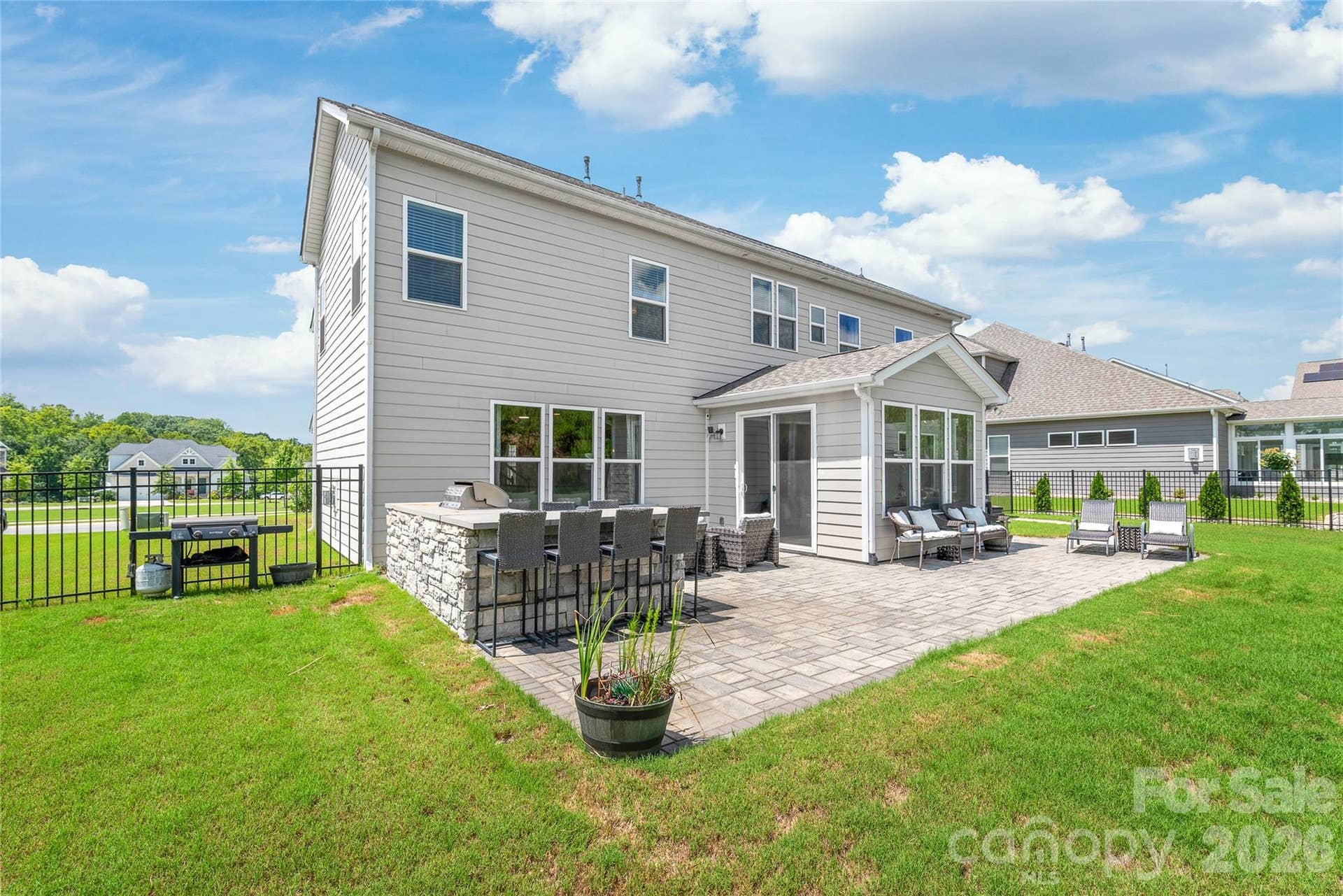 Fire up the grill...complete with an outdoor kitchen and bar seating for easy outdoor entertaining.