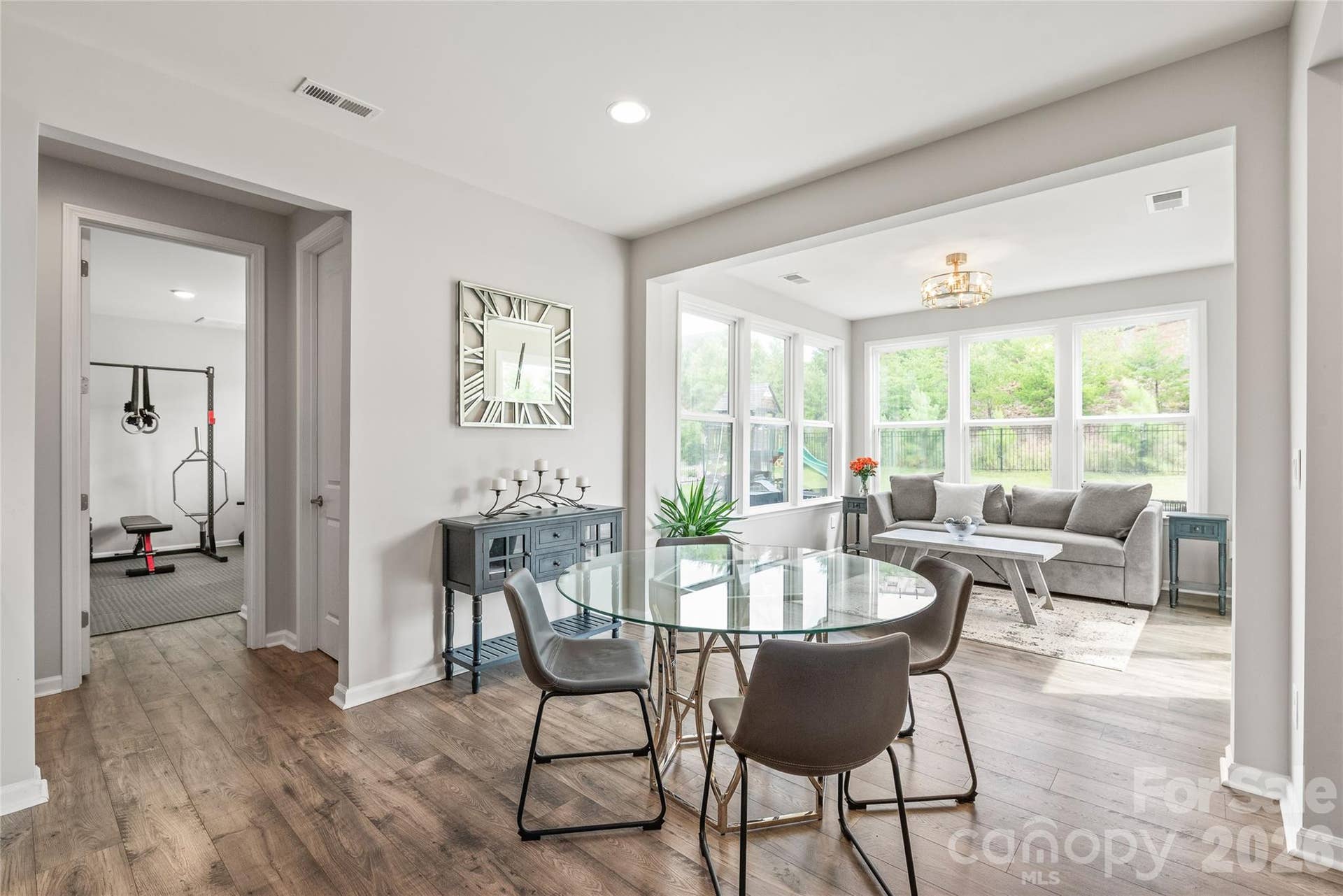 Just off the breakfast area, you'll find a generously sized walk-in pantry alongside a main-level guest bedroom and full bath...a flexible space that easily serves as a home gym, guest suite, or dedicated hobby room.