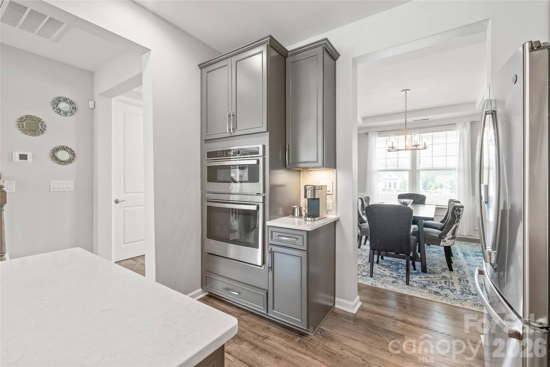 Sleek built-in microwave and wall oven units deliver a streamlined, professional look while keeping counter space completely clear for prep.