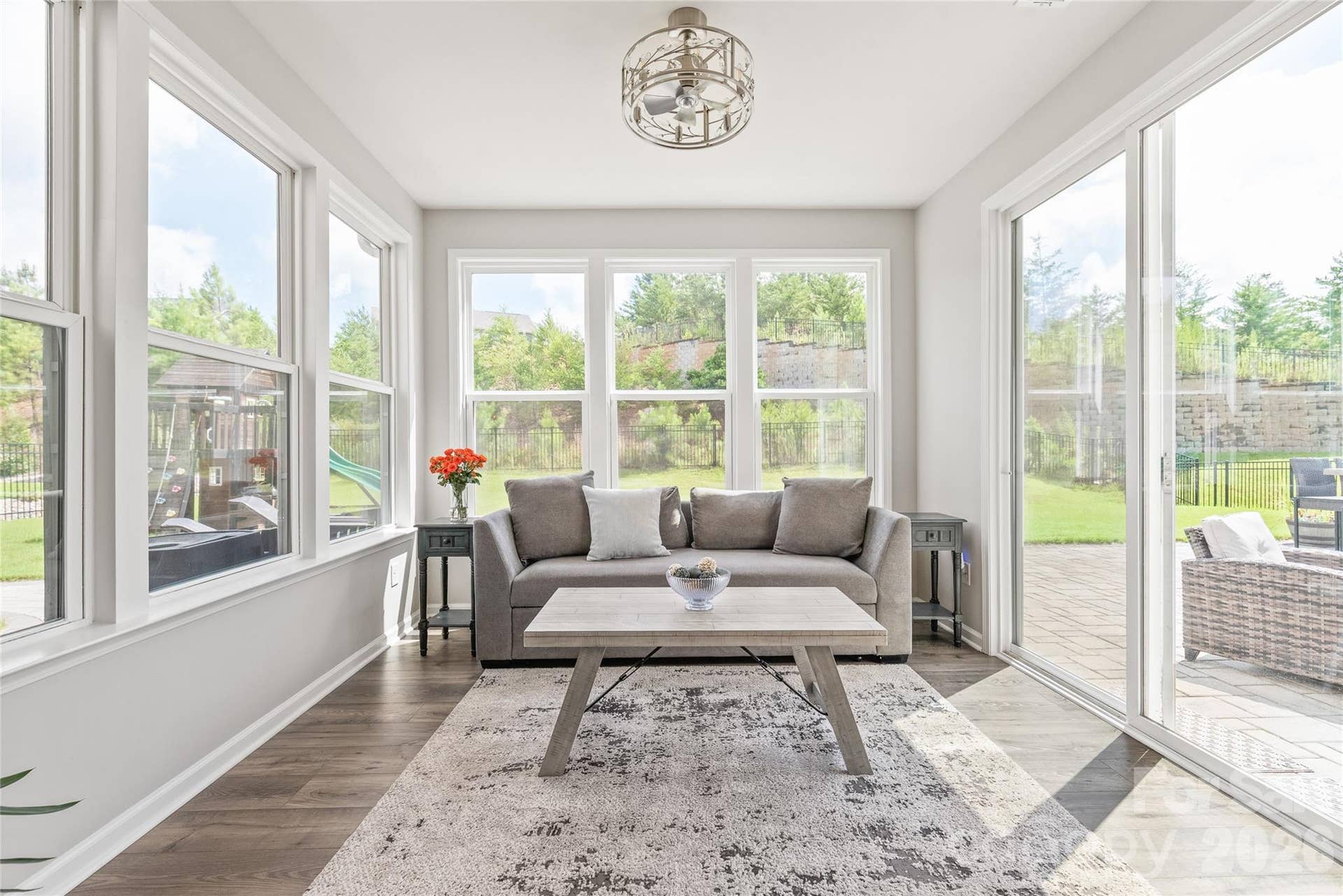 Featuring a modern fandelier, this sun-drenched space opens directly out to your private backyard oasis.