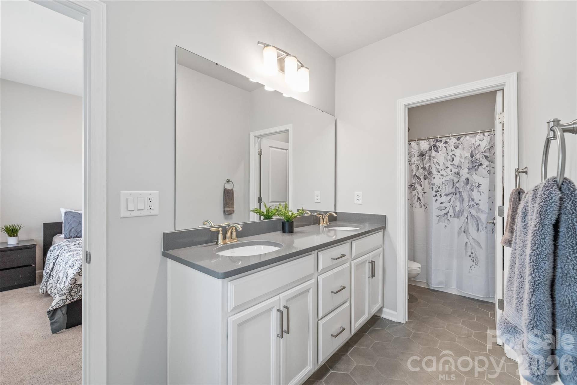 Perfectly designed for shared living, this Jack-and-Jill bathroom features dual sinks and a separate wet room with the tub and toilet...making busy morning routines seamless for Bedrooms 3 and 4.