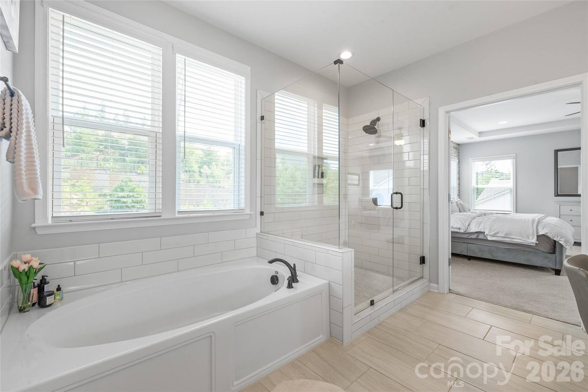 A spa-like retreat featuring a luxurious soaking tub and a spacious walk-in shower with a modern frameless glass surround.