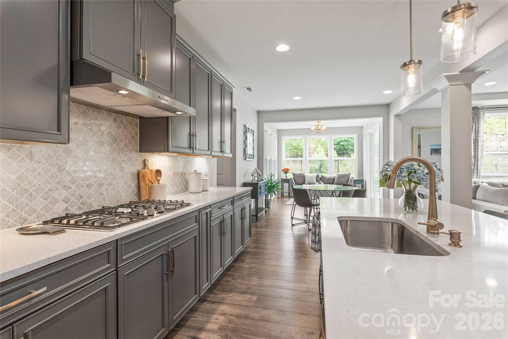 Designed for culinary precision and easy cleanup, the kitchen features a high-performance 5-burner gas cooktop and a sleek, deep single-basin undermount sink.