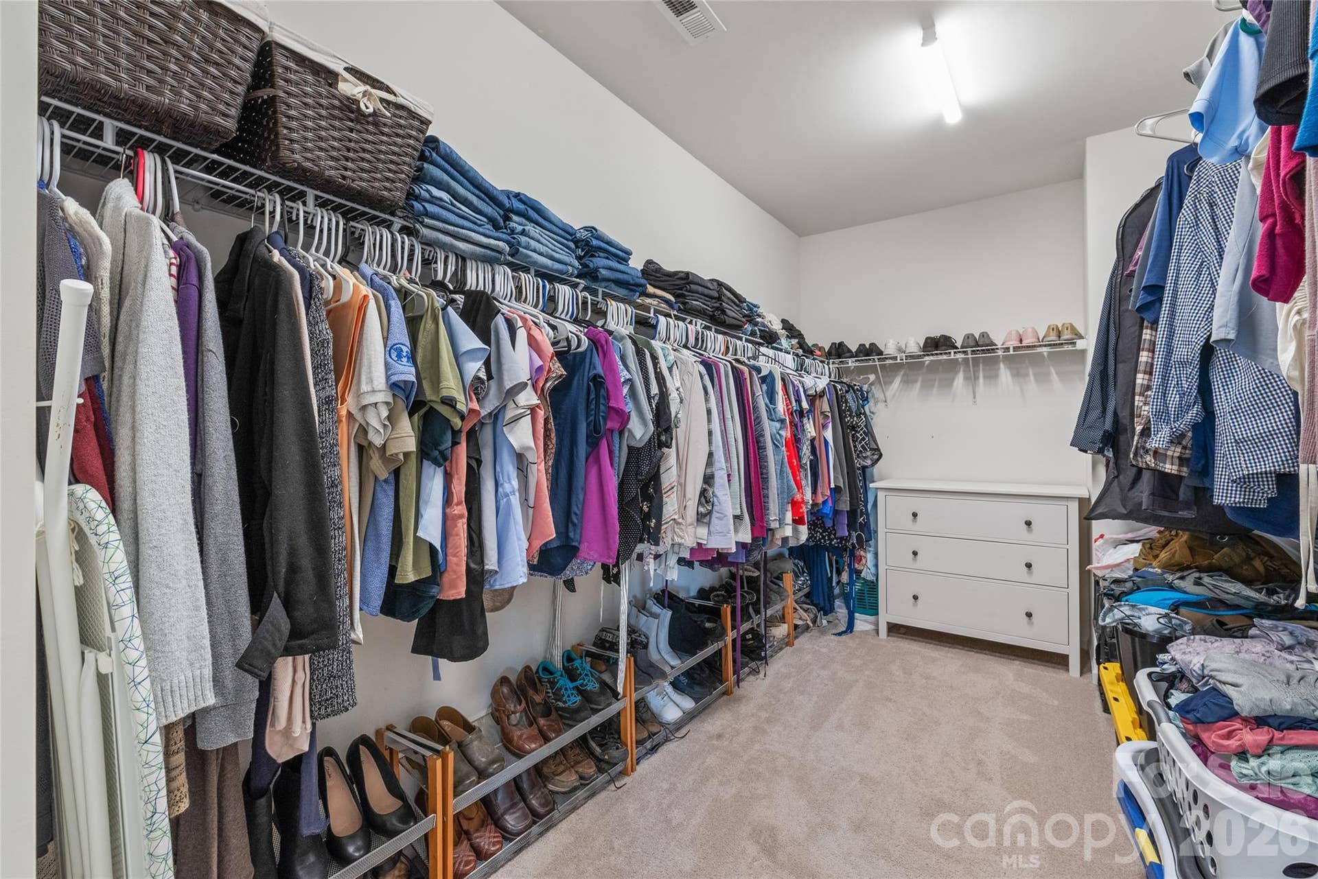 Generously sized primary walk-in closet with room for everything.