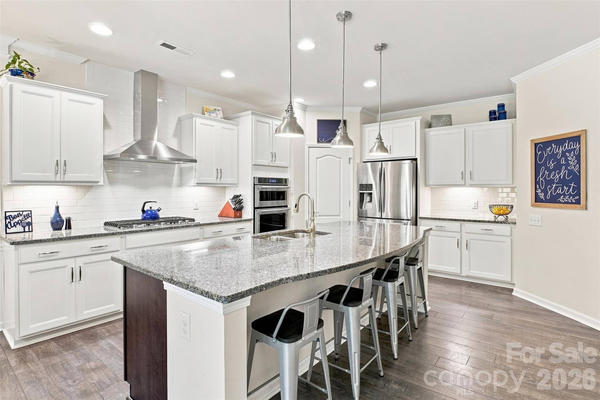 15704 Reynolds Drive, Indian Land, SC 29707 Beautiful and Bright kitchen with white cabinetry, granite counters, and stainless steel appliances