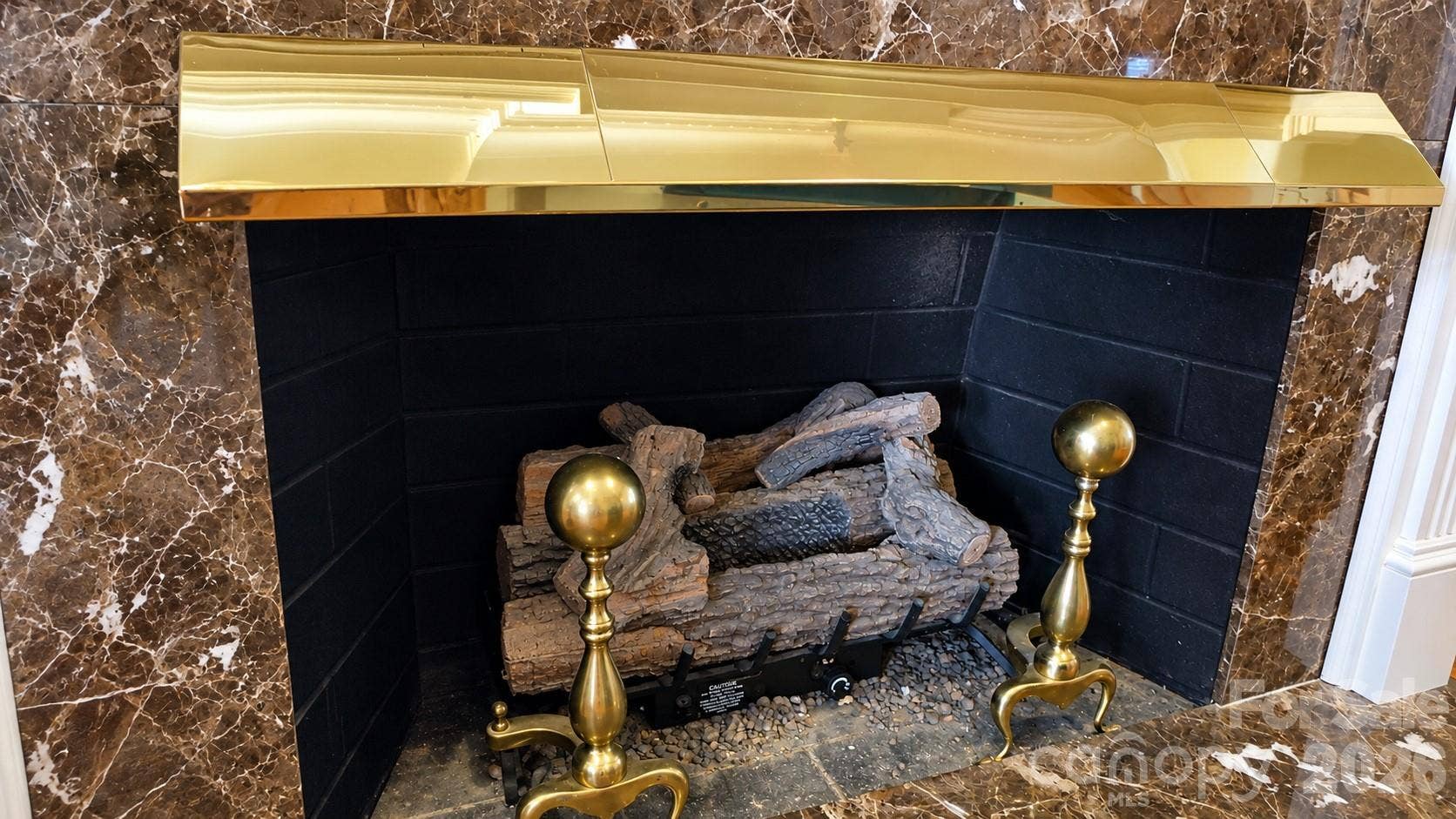 5480 Glen Forest Drive, Charlotte, NC 28226 Gas fireplace with antique brass andiron's. Note: the Fireplace is now gas log but can be converted back to wood burning.