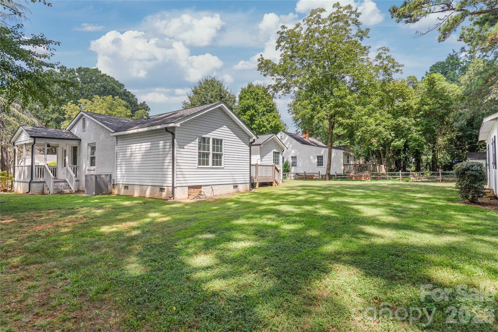 Another angle of this amazing outdoor retreat! Taking a closer look at the covered side porch right off the living room.