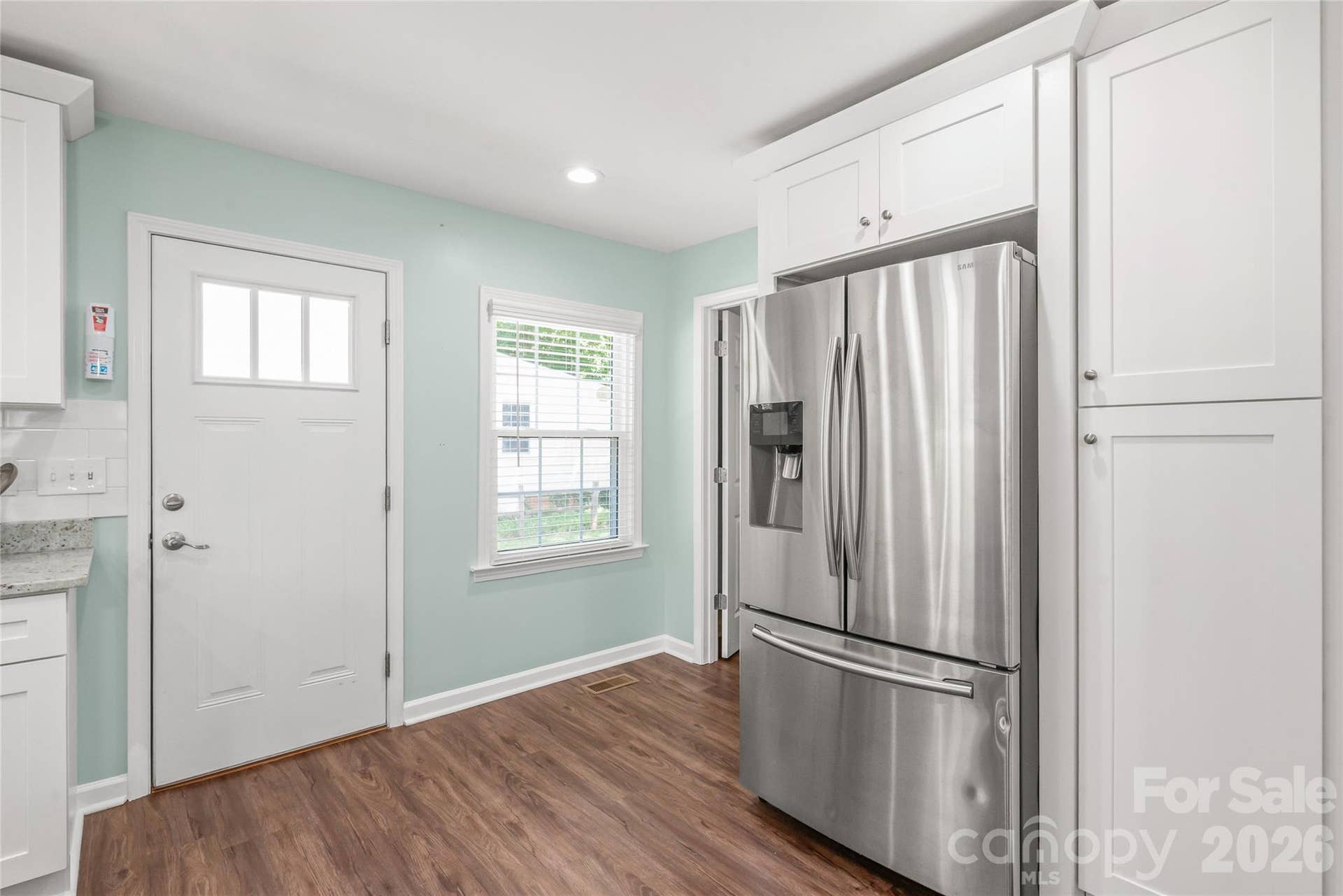 Stainless steel refrigerator (2019) plus a custom built-in pantry offering plenty of extra storage and organization.