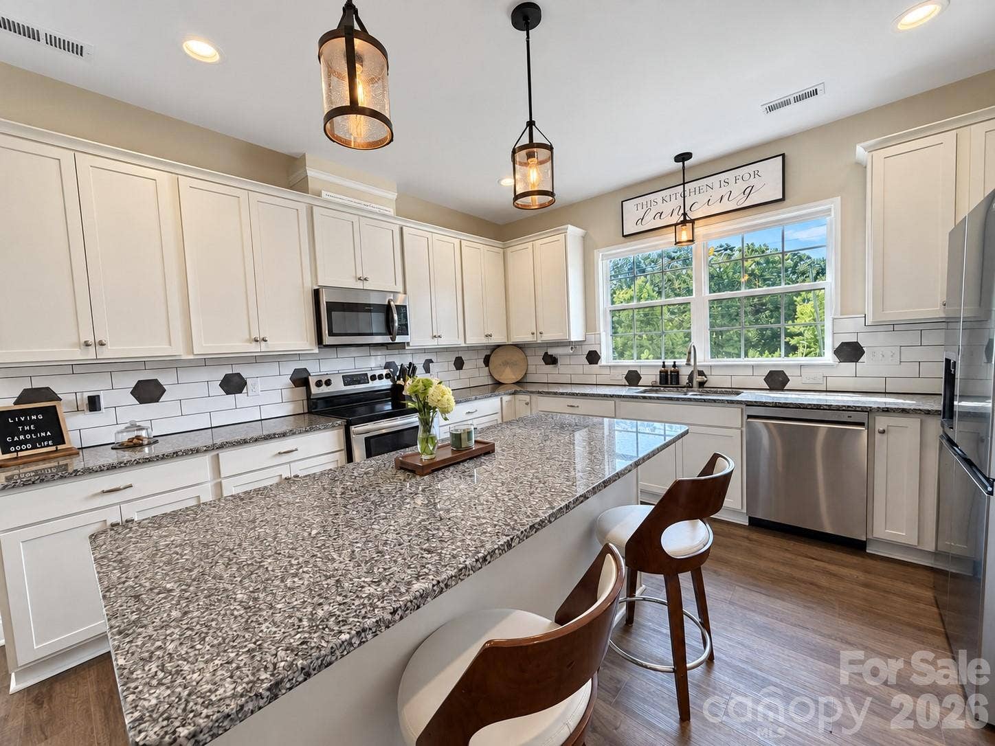 9201 Providence Road S, Waxhaw, NC 28173 Beautiful kitchen with white cabinets, granite counters, and stainless steel appliances
