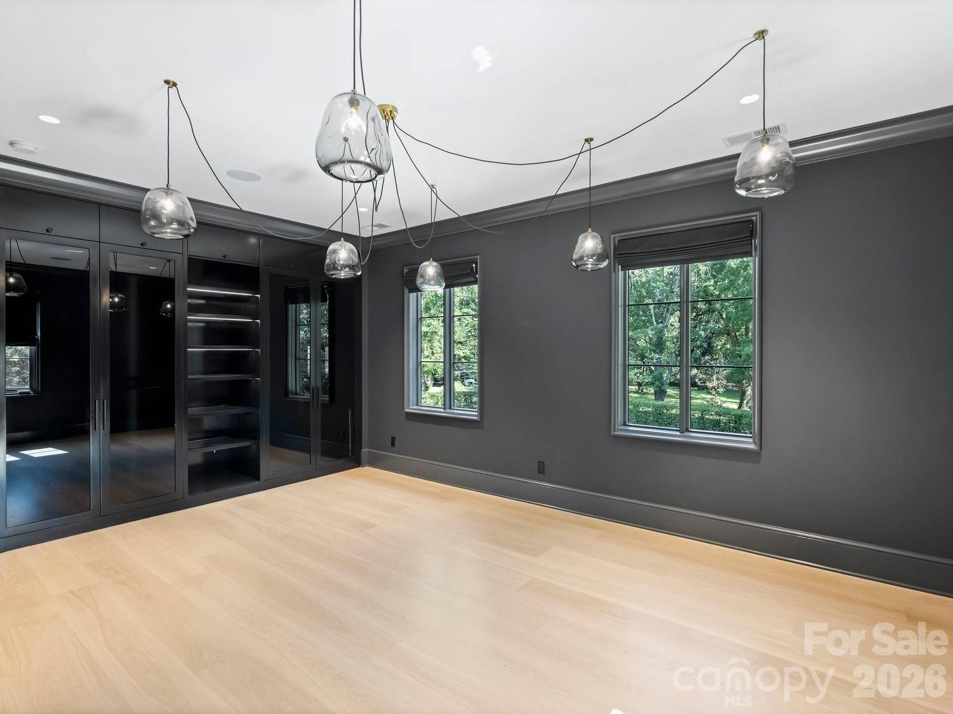 Upper level Guest Suite 1 with fun modern custom closet system