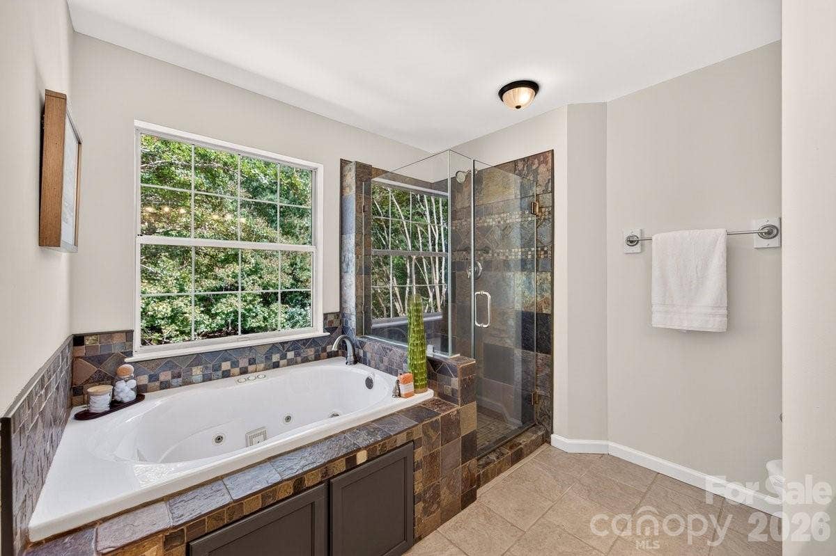 2901 Firewood Drive, Matthews, NC 28105 Frameless glass and tile shower plus a tub.