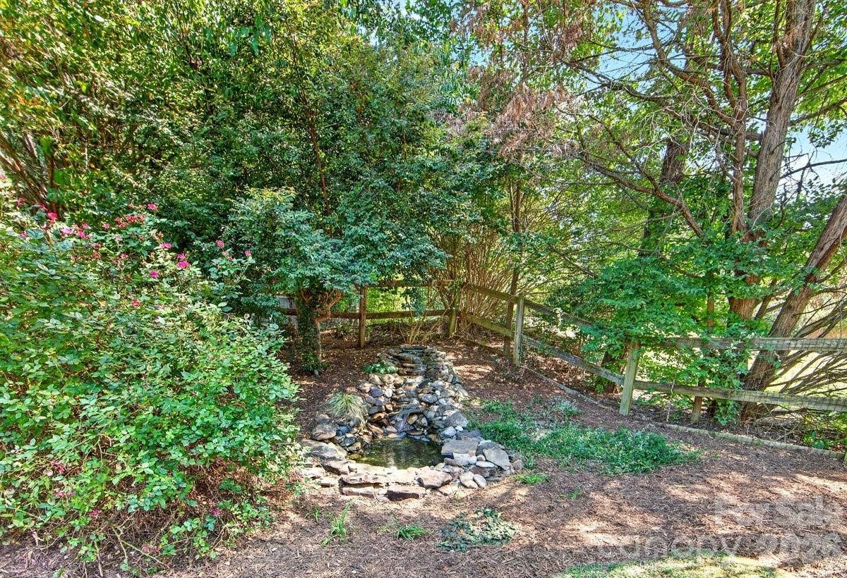 2901 Firewood Drive, Matthews, NC 28105 Water feature adds to the peaceful backyard.