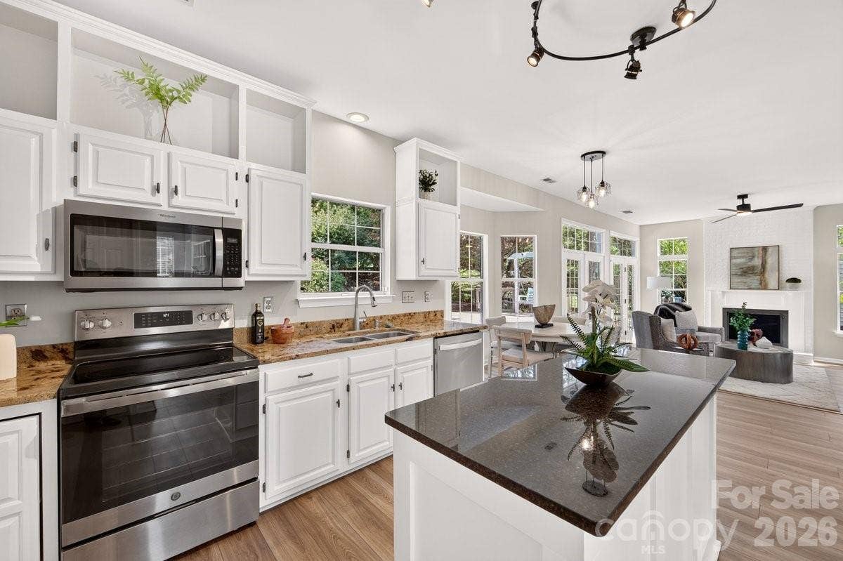 2901 Firewood Drive, Matthews, NC 28105 Fun open shelving at the top of beautiful white cabinetry.
