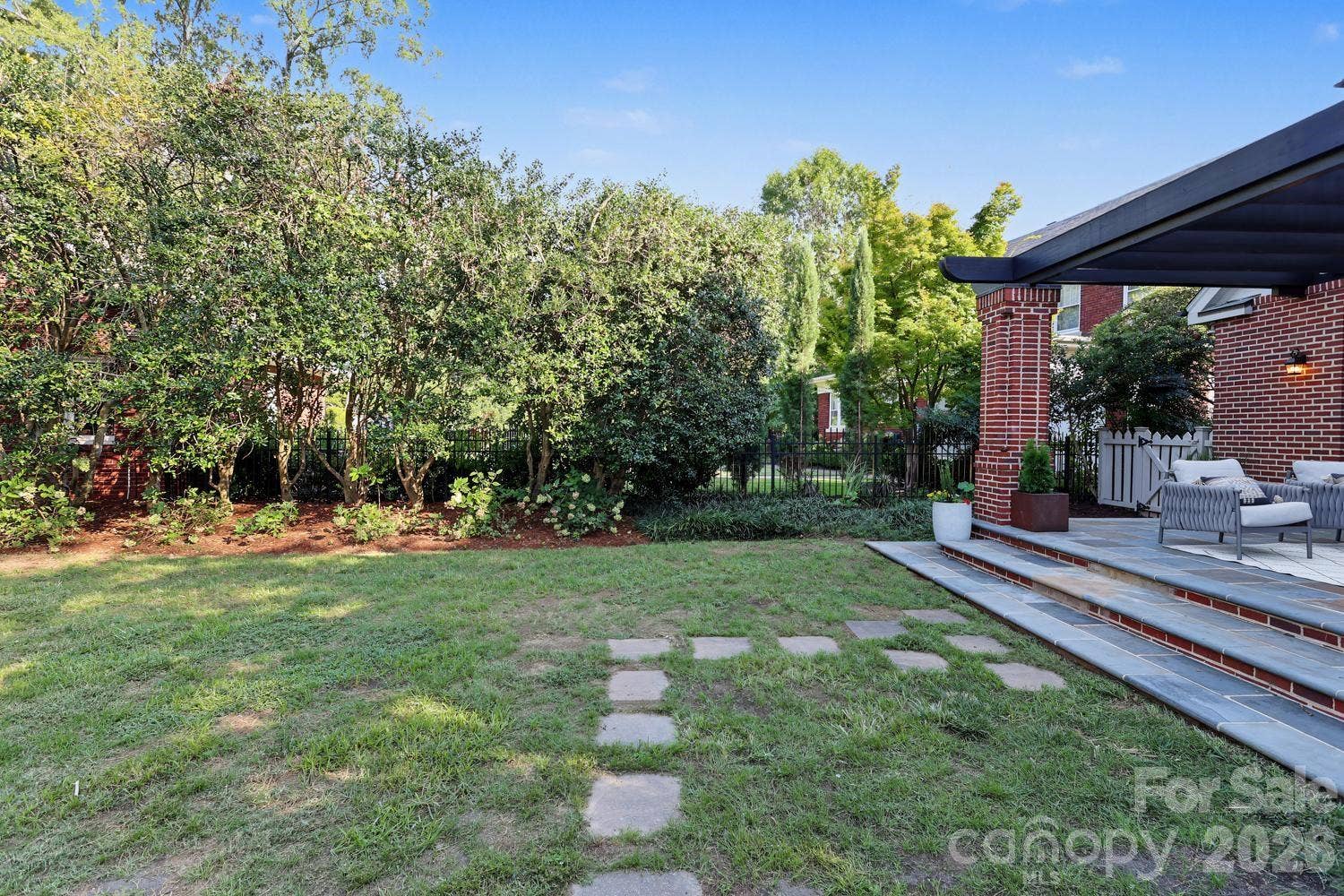 Private rear yard with mature plantings
