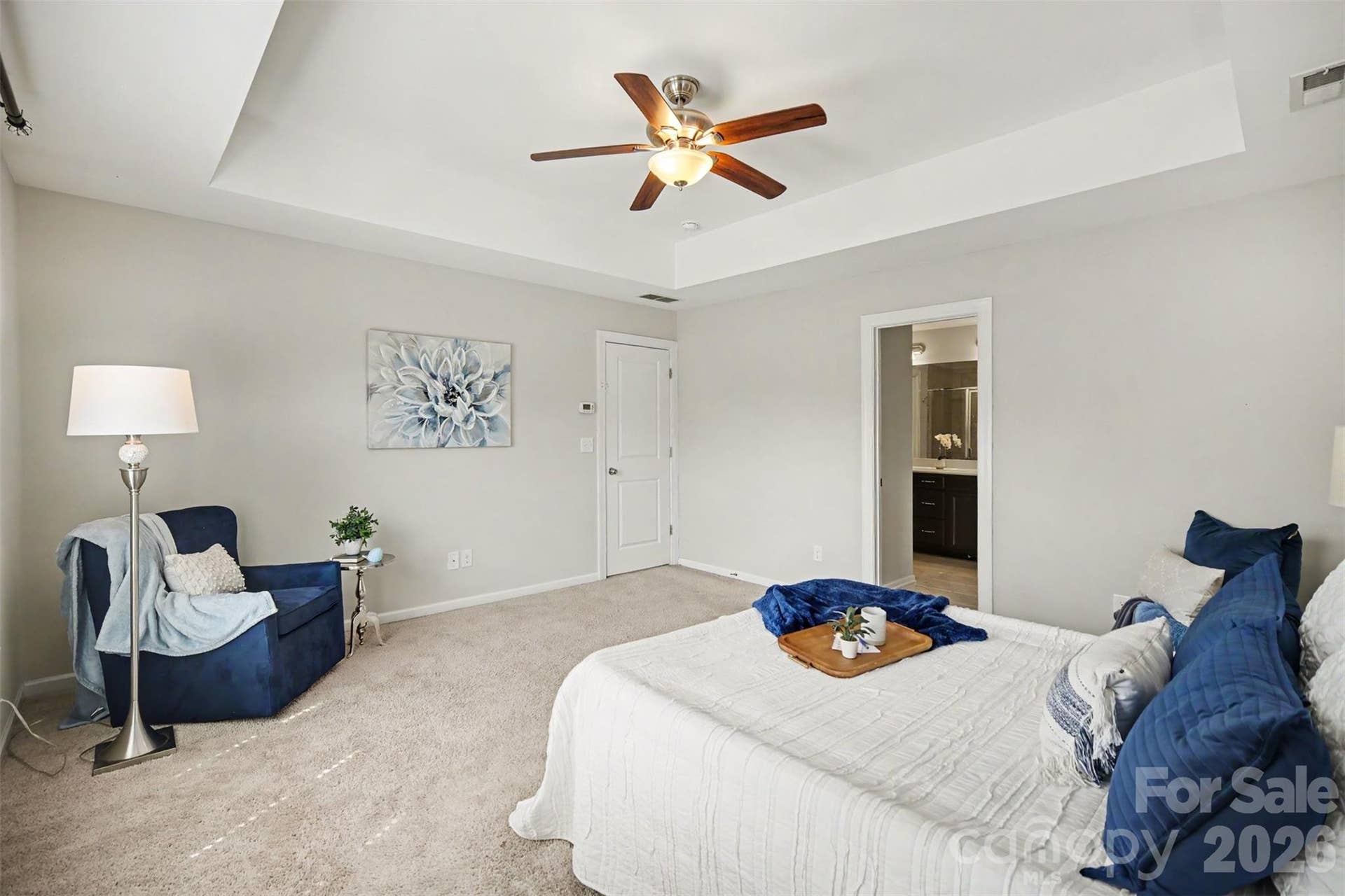 Primary suite with tray ceiling and lots of natural light