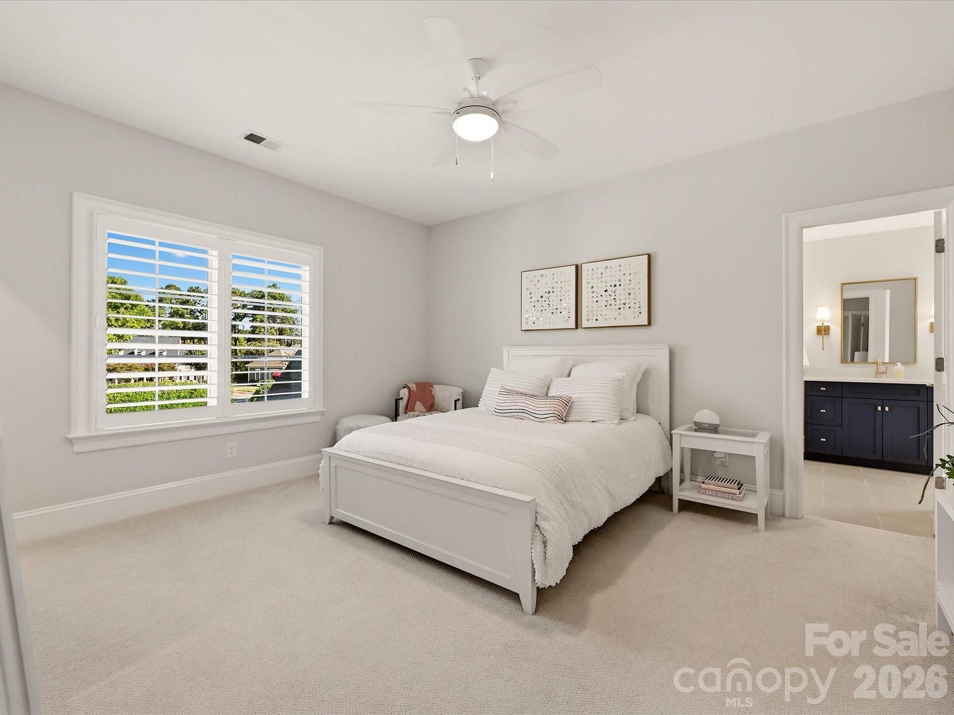 Spacious Bedroom 2 offers abundant natural light, generous proportions, and convenient access to a private adjoining full bath.