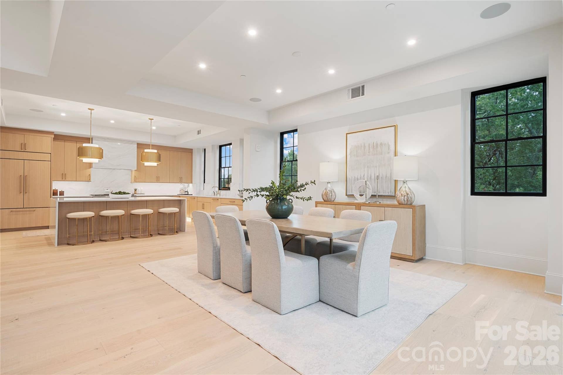 409 Queens Road, #503, Charlotte, NC 28207 The open sightline and flowing floorplan continue across the dining and kitchen areas. While the light oak cabinetry, wide-plank floors and bright, contemporary design tie it all together beautifully.