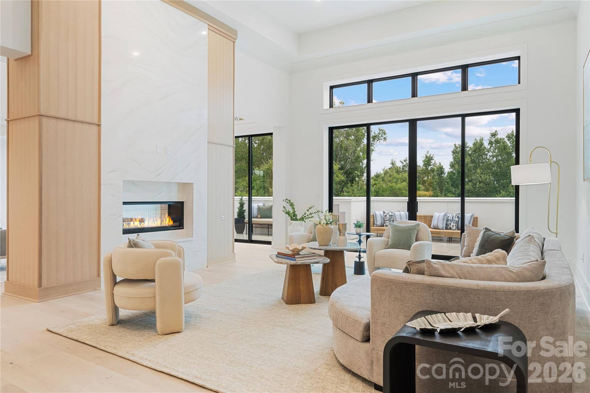 409 Queens Road, #503, Charlotte, NC 28207 Light-filled living space with oversized glass doors, treetop views and seamless access to the private terrace.