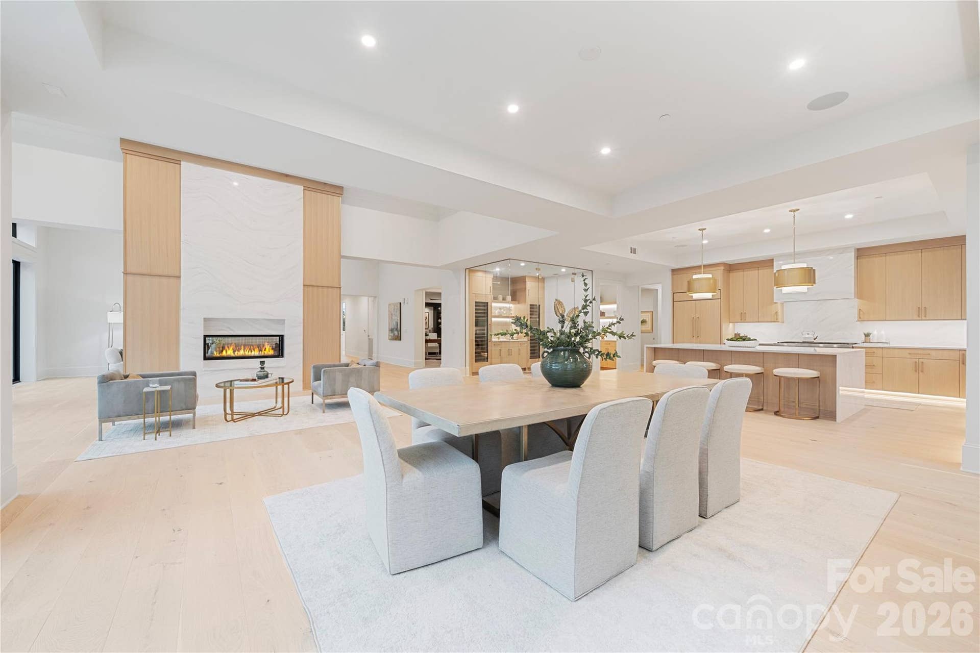 409 Queens Road, #503, Charlotte, NC 28207 A sweeping view of the dining room, gourmet kitchen and statement fireplace highlights the homes exceptional scale and open-concept design.