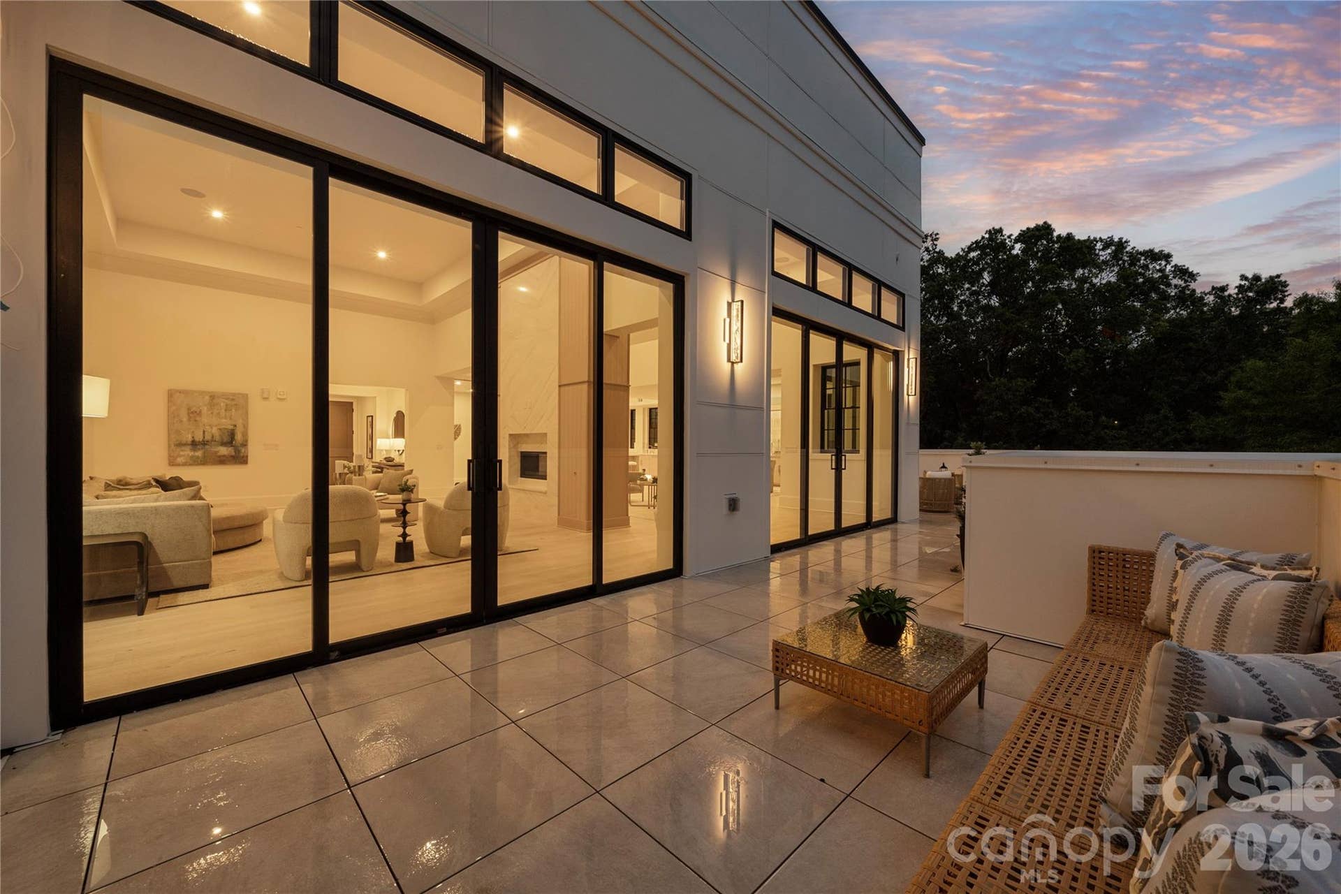 409 Queens Road, #503, Charlotte, NC 28207 The expansive terrace with walls of glass opening to the illuminated living spaces, creates a seamless indoor-outdoor setting that is unique in Charlotte and perfect for relaxing evenings and entertaining.