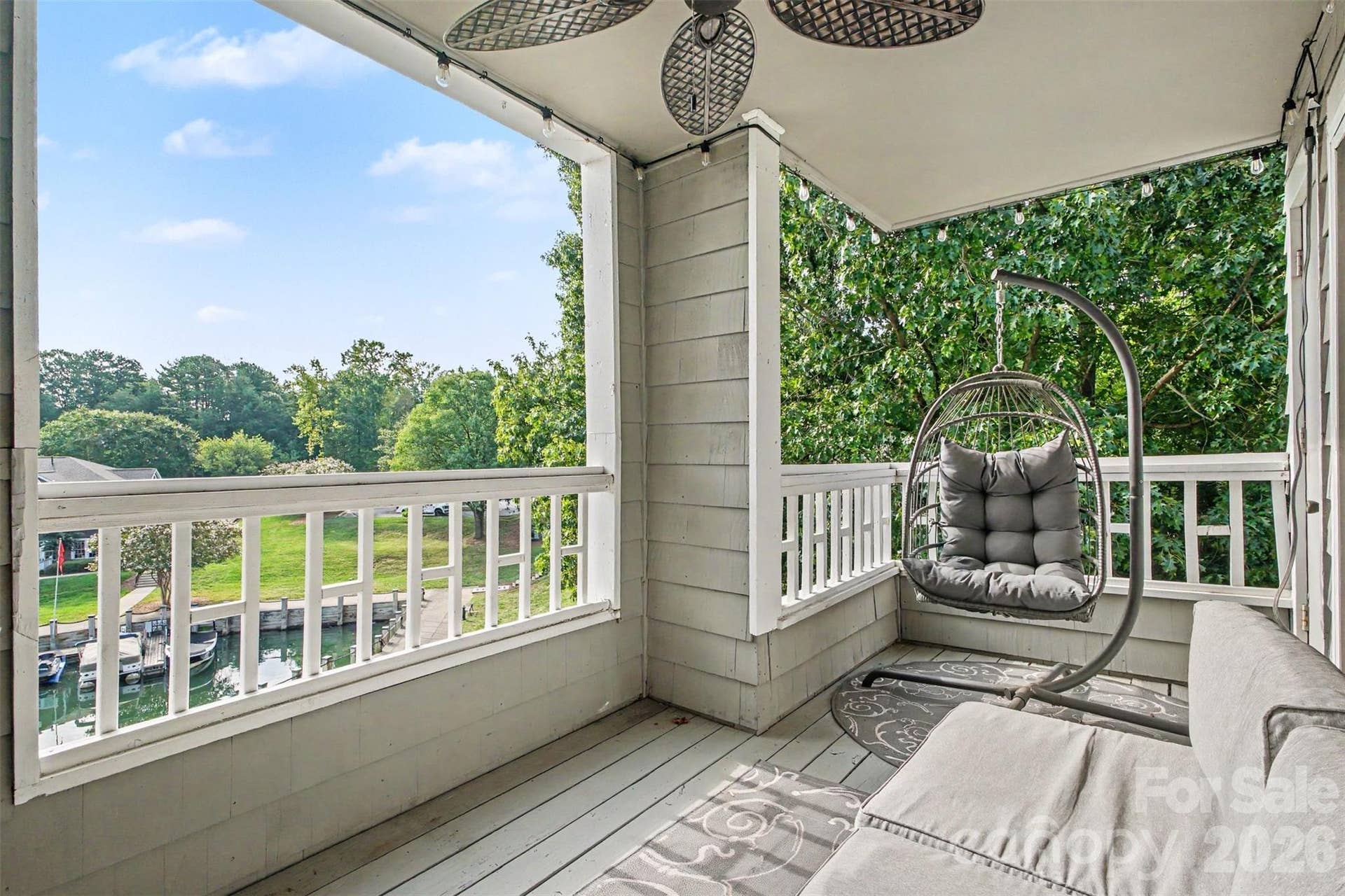 End unit with balcony offering outdoor living space with harbor and water views.