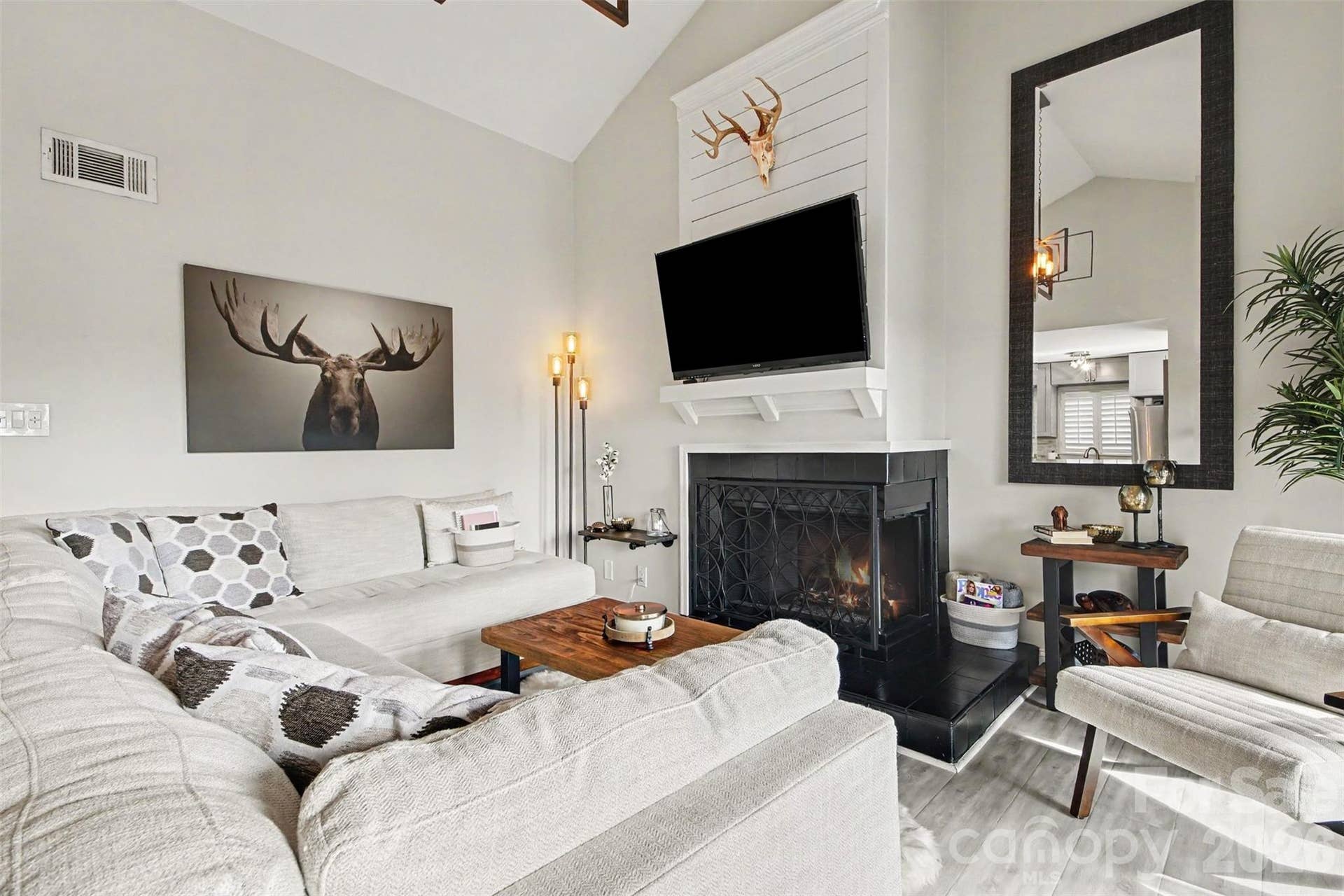 Spacious living area with vaulted ceilings and fireplace.