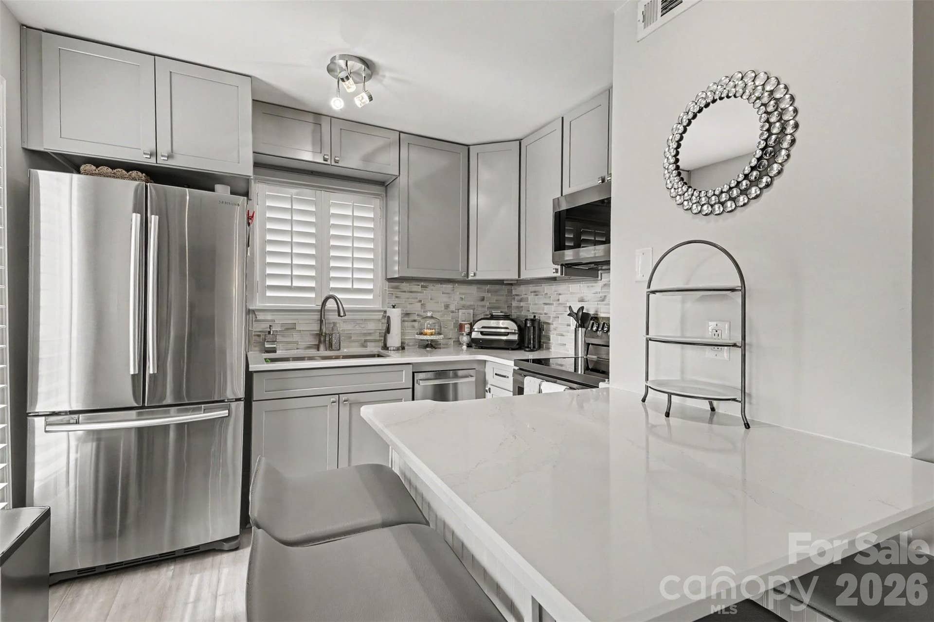 Updated kitchen with 38-inch cabinets, pull-out, dishwasher and quartz countertops.