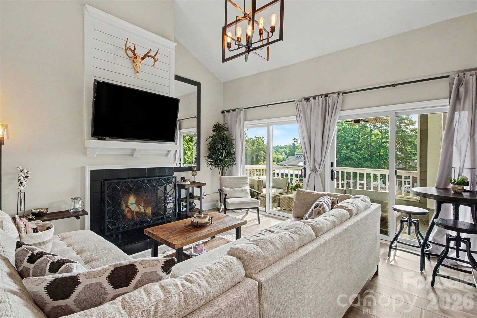Spacious living area with vaulted ceilings, fireplace with waterviews.