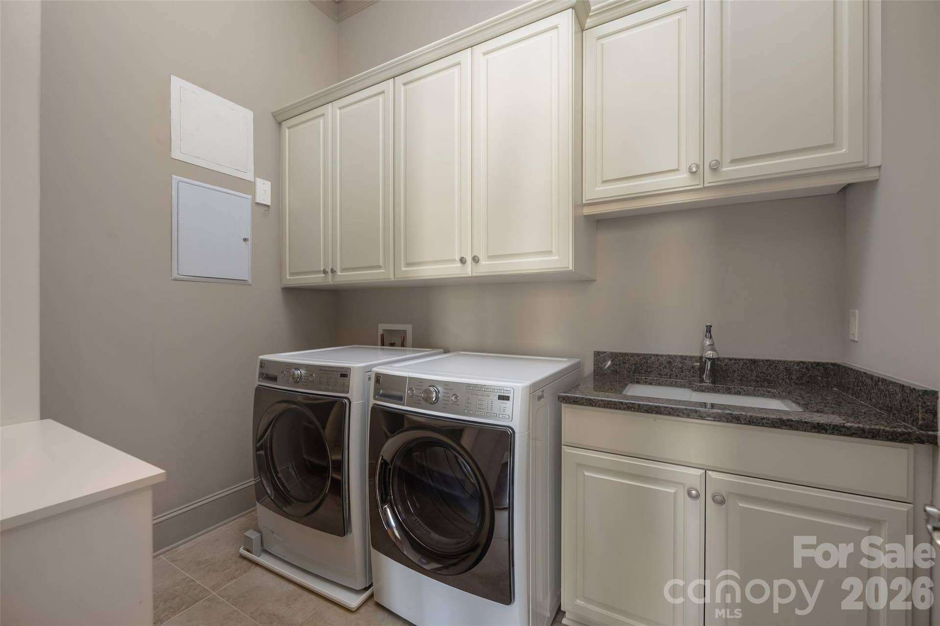 2823 Providence Road, #280, Charlotte, NC 28211 Full laundry room with cabinets, sink and side-by-side washer and dryer