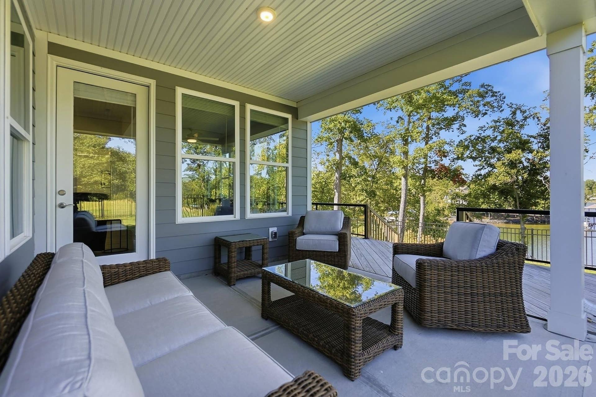8032 Longwaters Court, York, SC 29745 Outside, enjoy an aluminum-fenced backyard and an expanded back deck with aluminum railing and glass panels, providing an ideal spot to take in the scenery