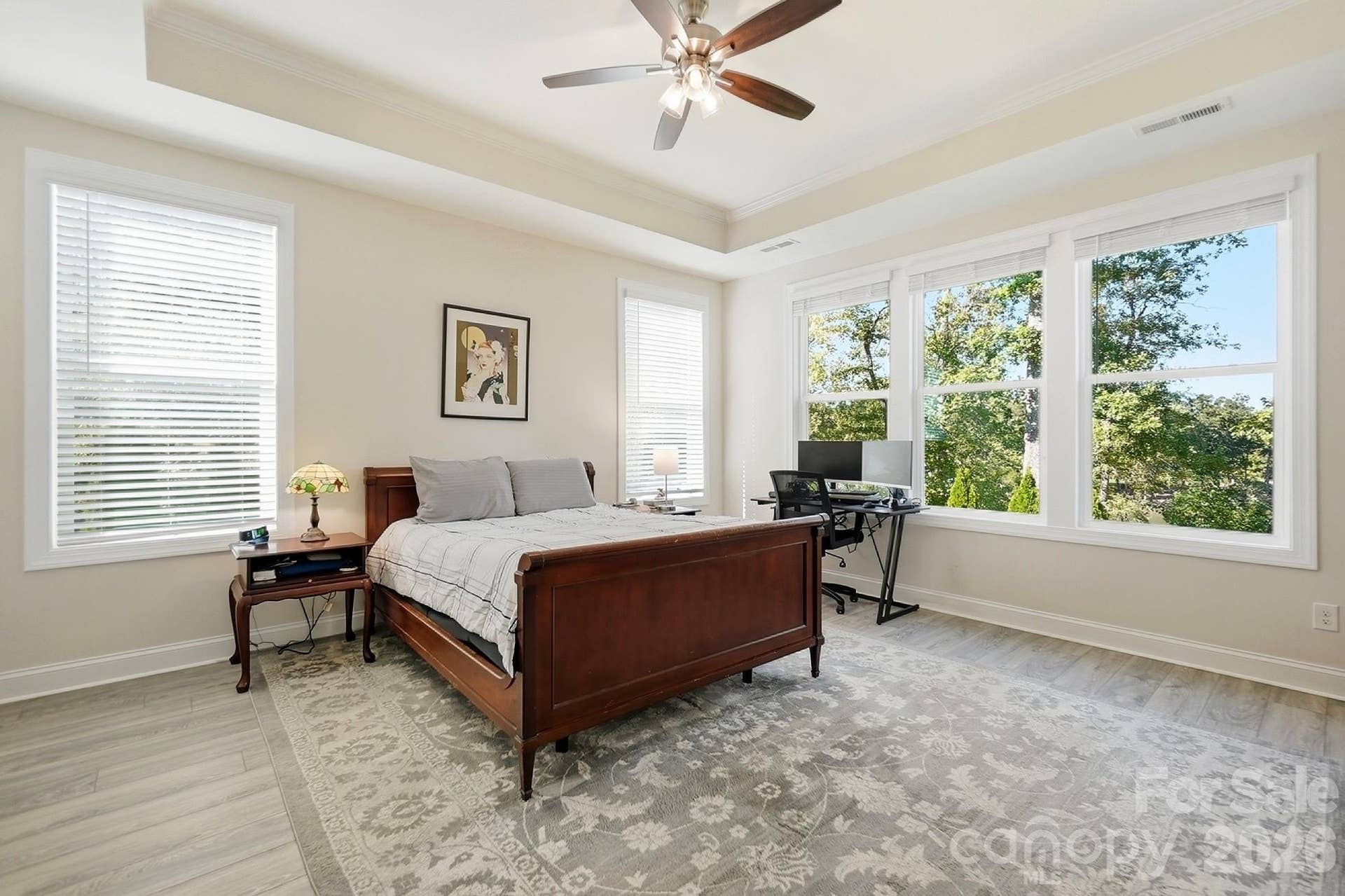 8032 Longwaters Court, York, SC 29745 The private primary suite captures the stunning lake views and features a tray ceiling