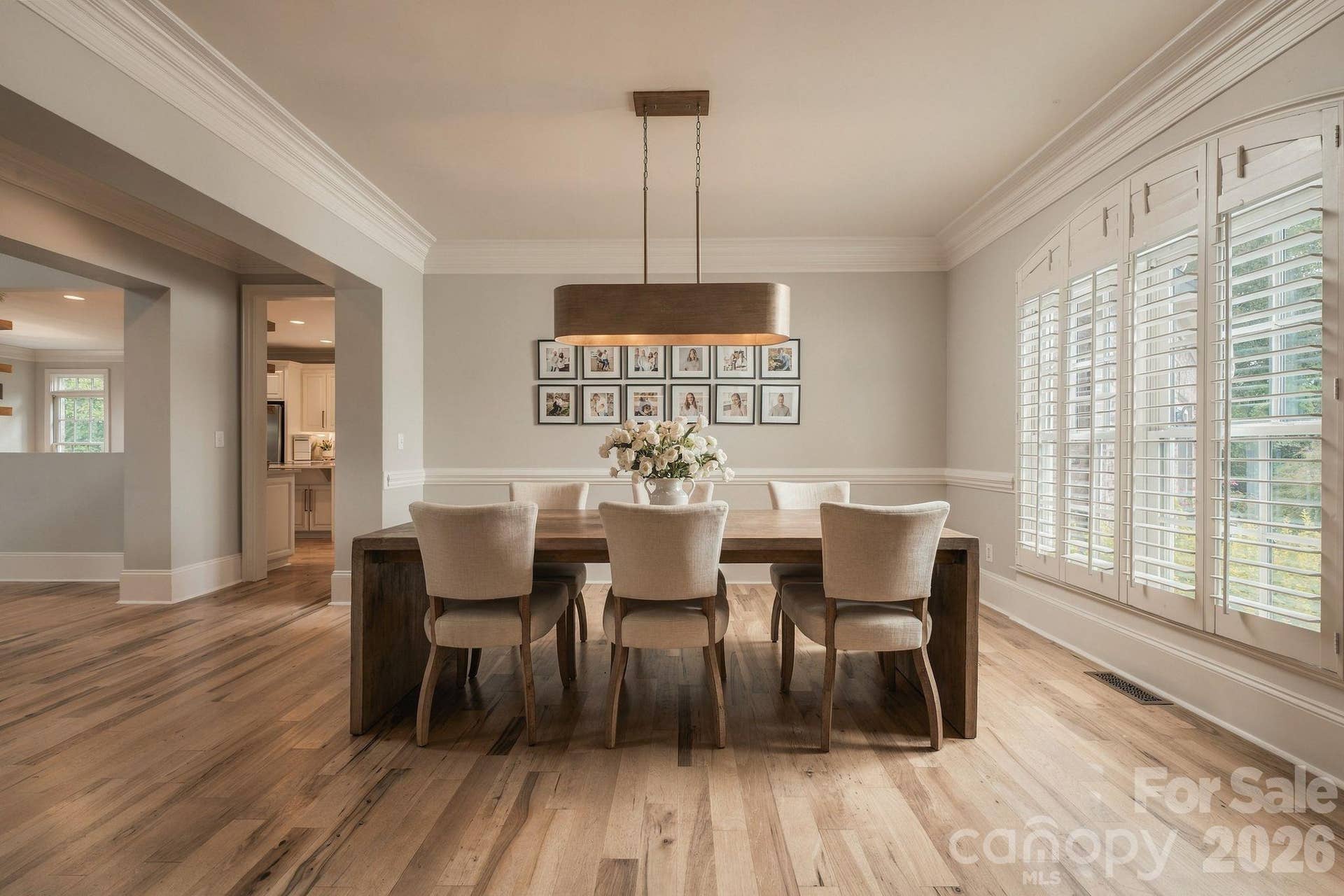 Formal dining complemented by natural wood floors