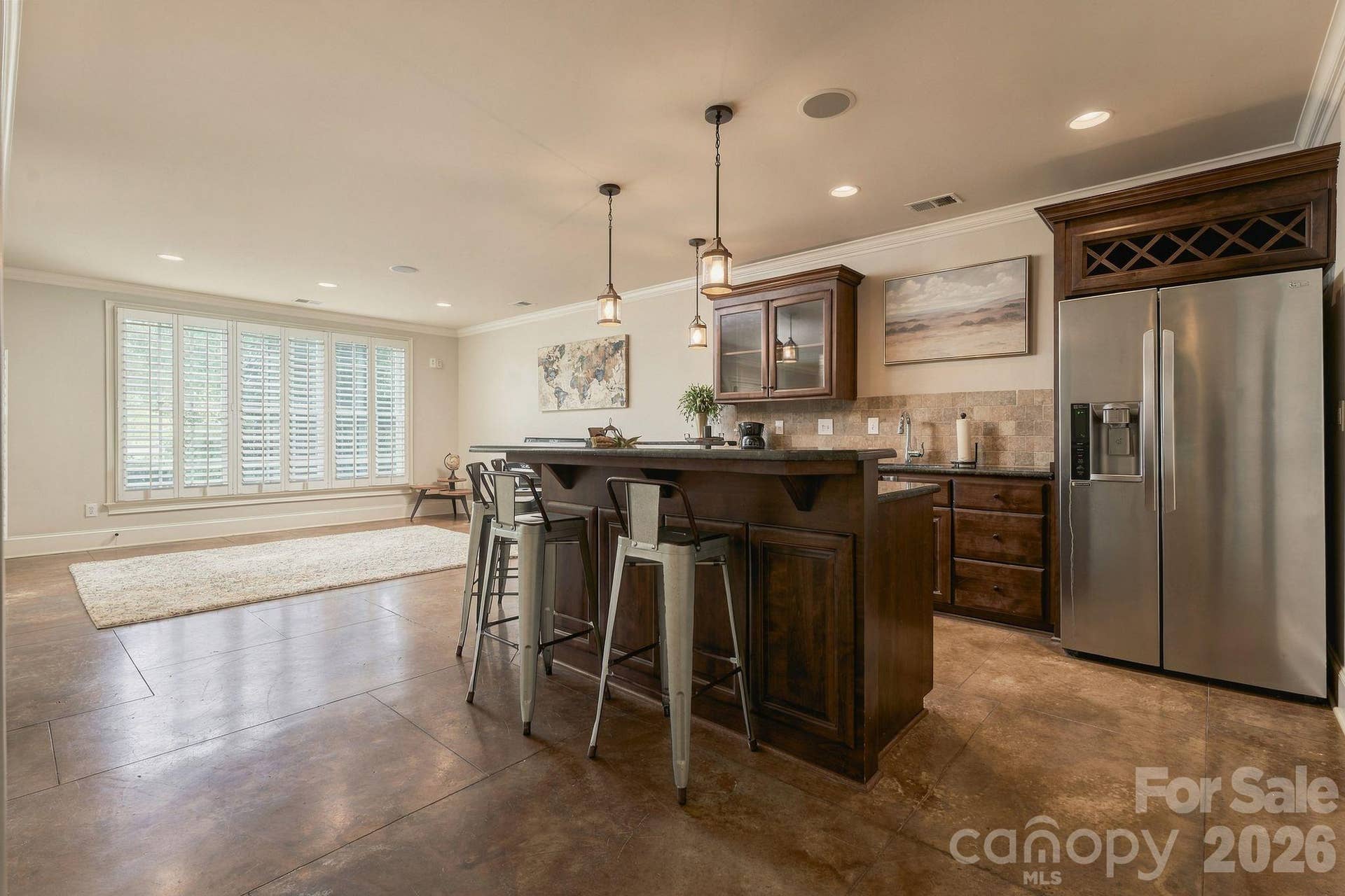 Basement bar/kitchenette features full refrigerator, dishwasher, and sink