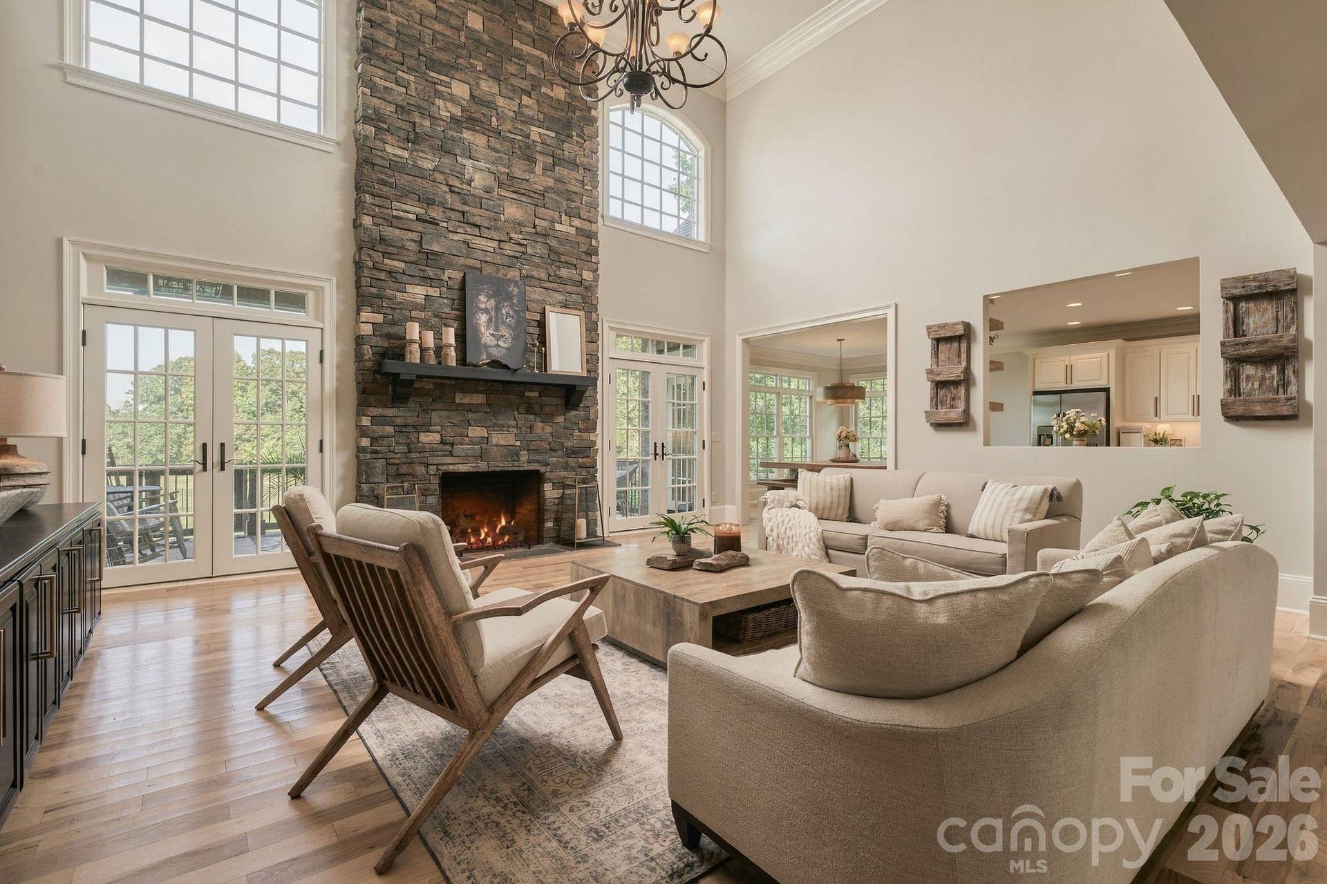 Grand two-story great room anchored by stone floor to ceiling gas fireplace