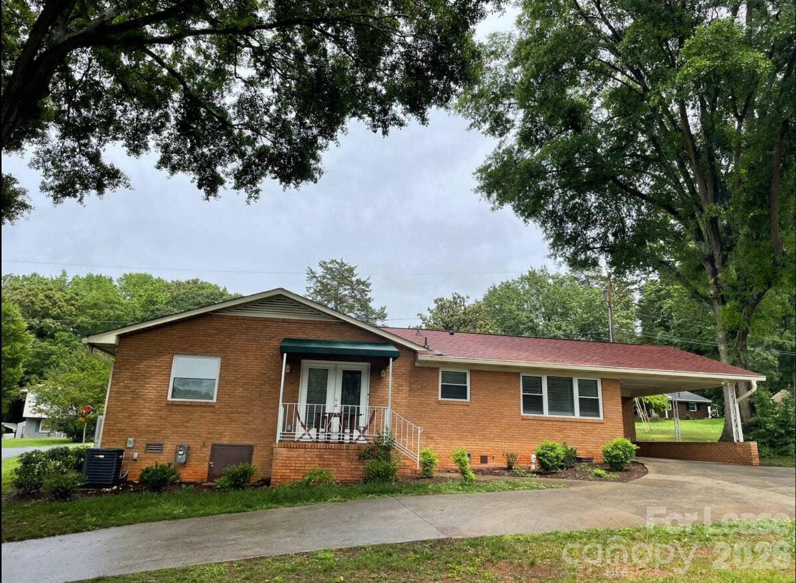 Rear entrance, driveway & carport