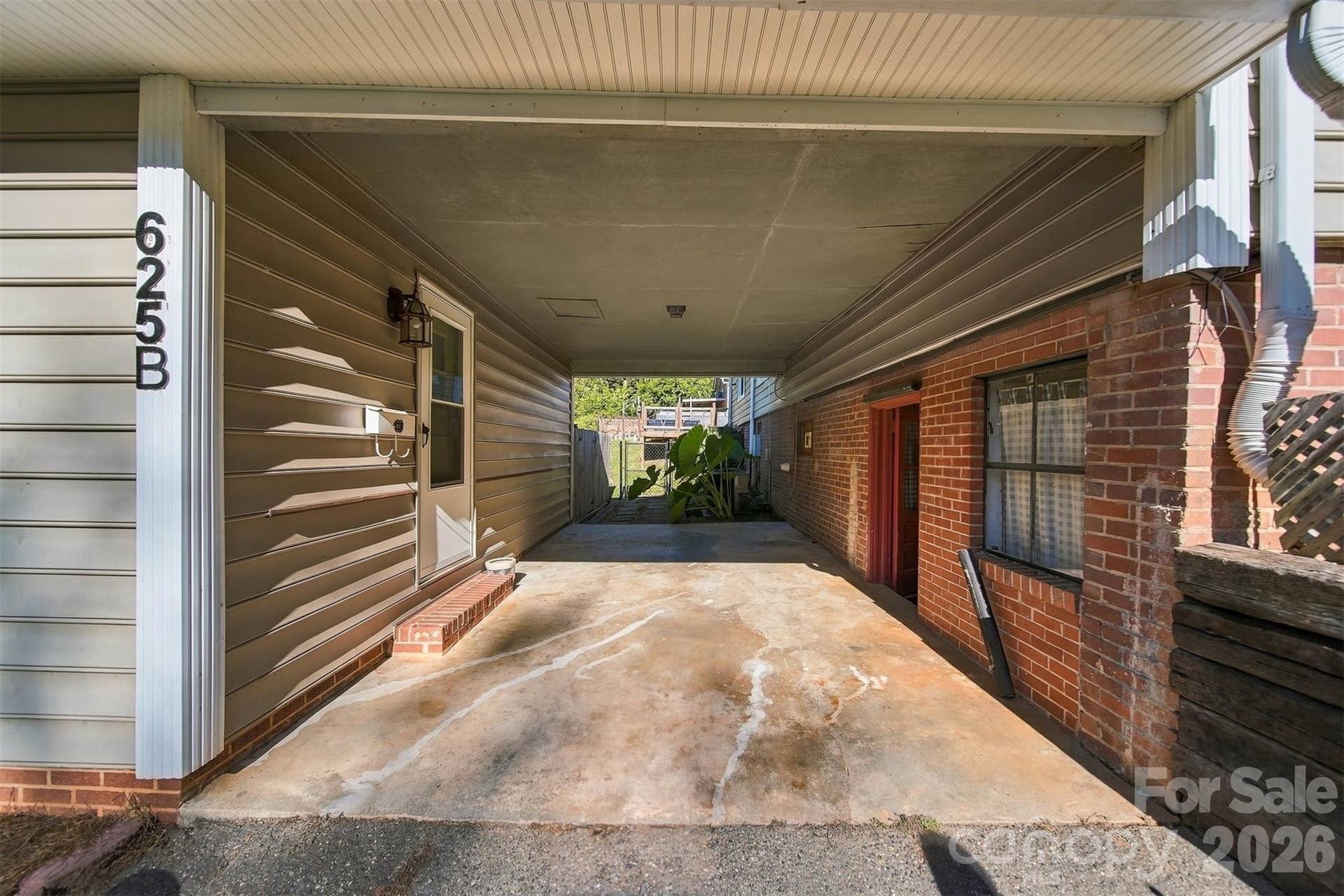 covered patio area between basement walkout and apartment.