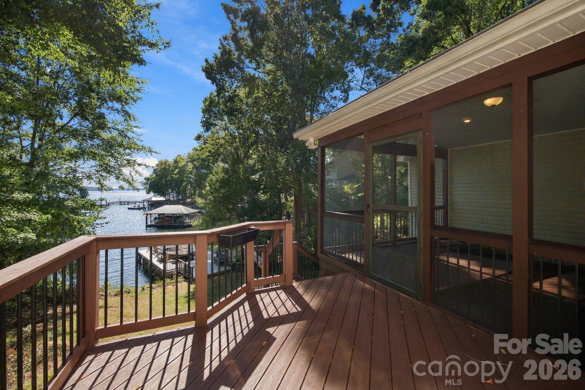Open deck with stairs to lower deck and lake