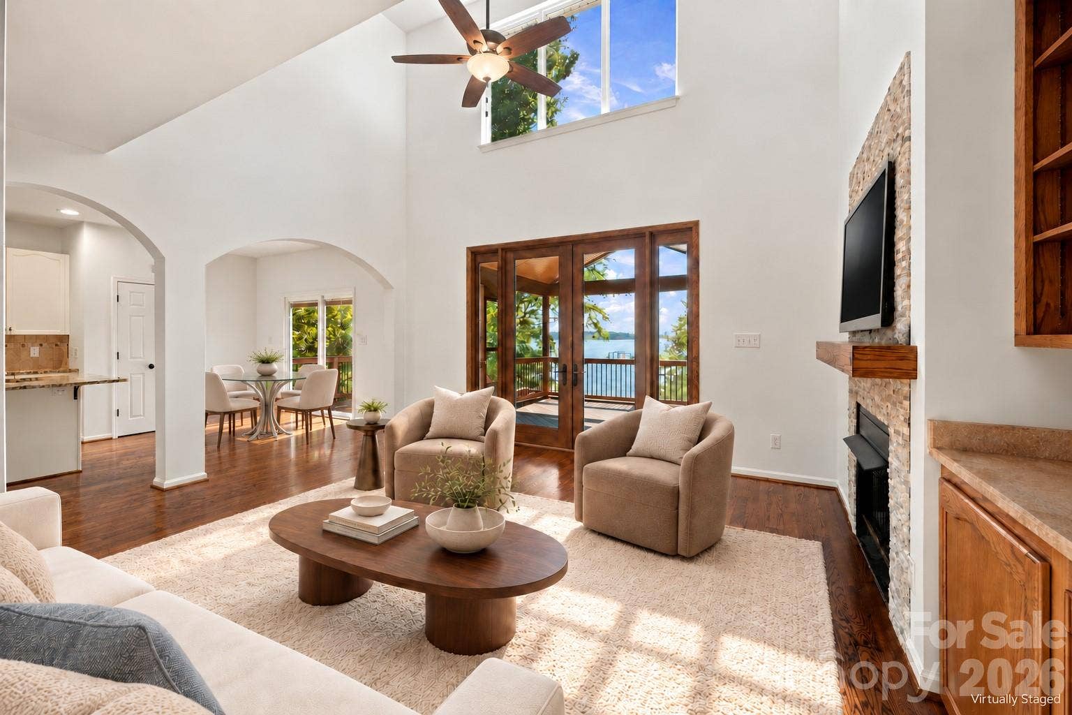 Large French doors open the room to the screened-in deck and beautiful lakeview staged