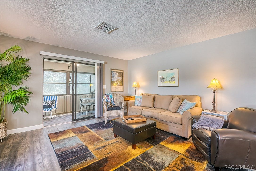 23 Dogwood Drive, Homosassa, FL 34446 Living Room Opens onto Enclosed Lanai for extra seating or dining.