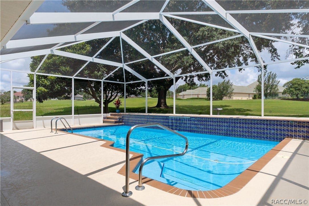 huge pool with waterfall overlooking golf course